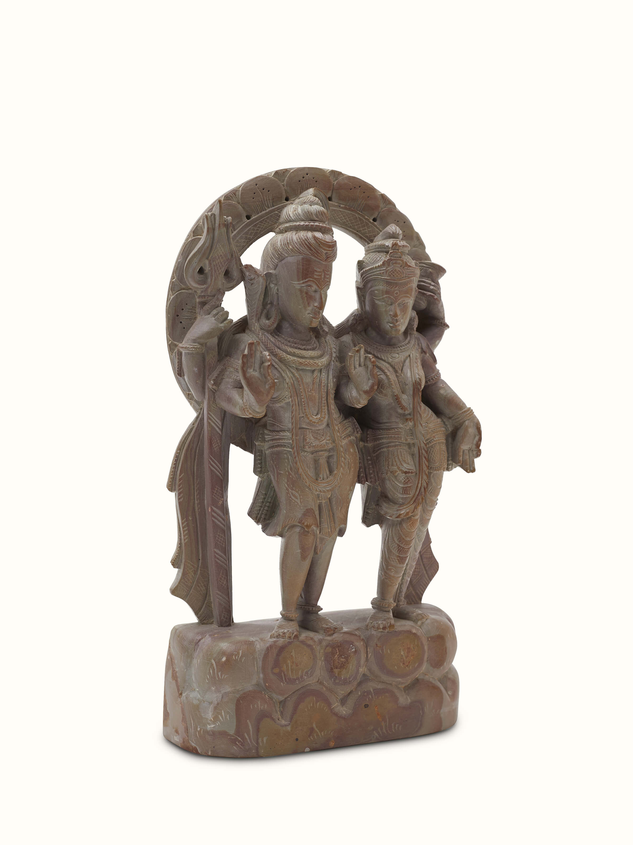 Side view of carved stone Shiva & Parvati idol, focusing on the craftsmanship and fine details.