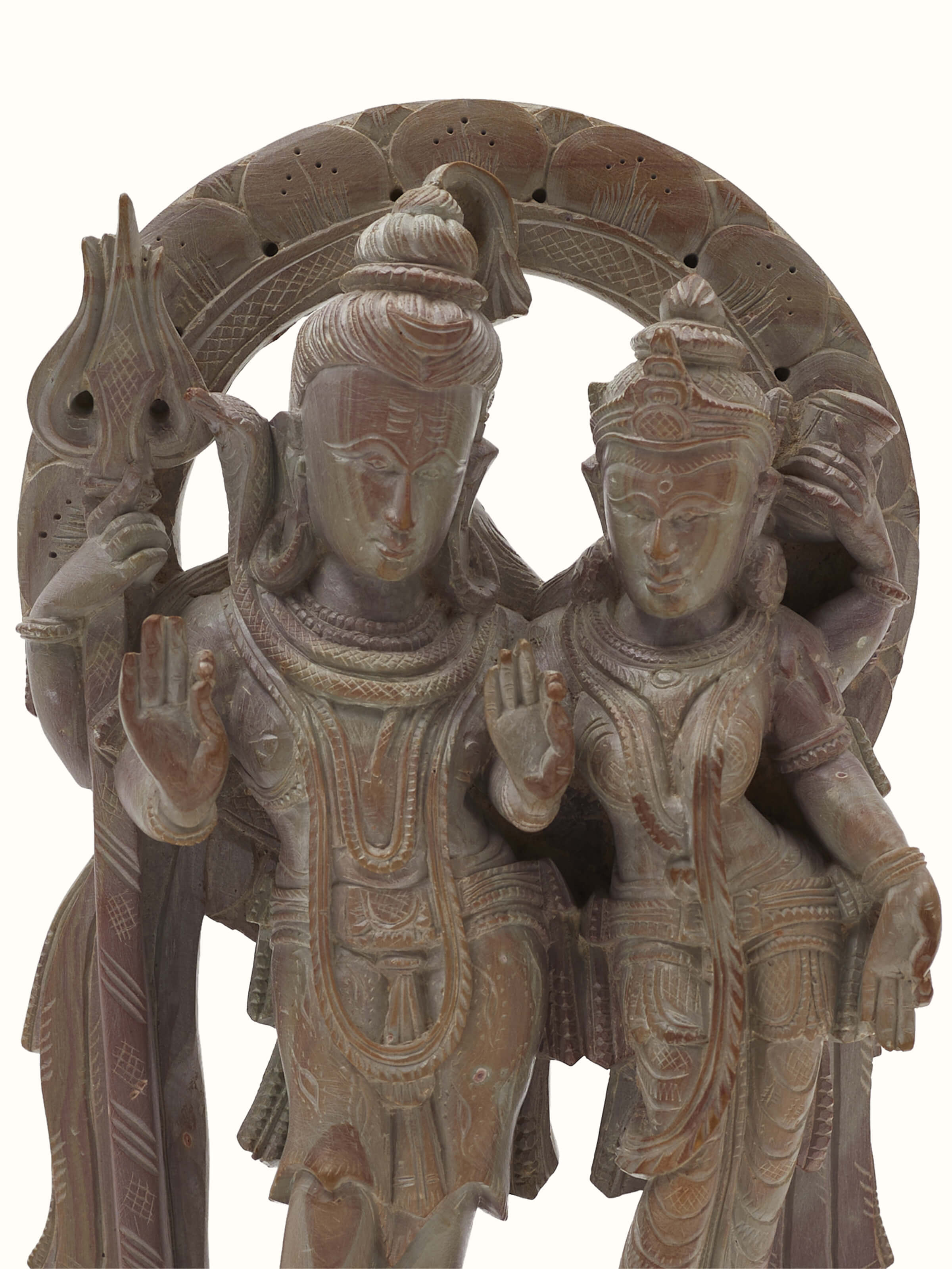 Carved stone Shiva & Parvati idol displayed with a focus on the intricate carvings and religious significance.