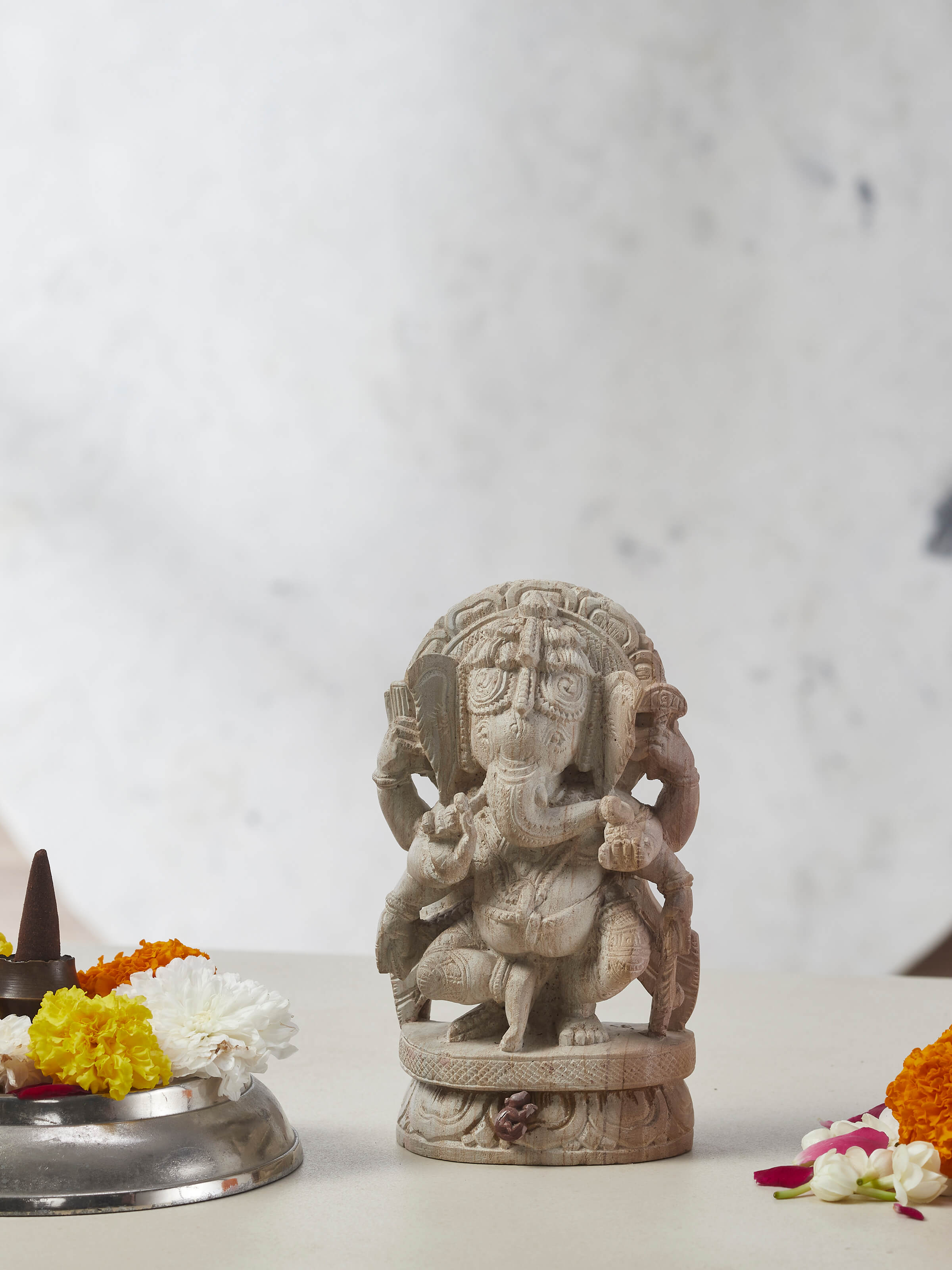 Side view of Divine Carved Stone Ganapathi Idol showcasing the stone texture and detailed craftsmanship