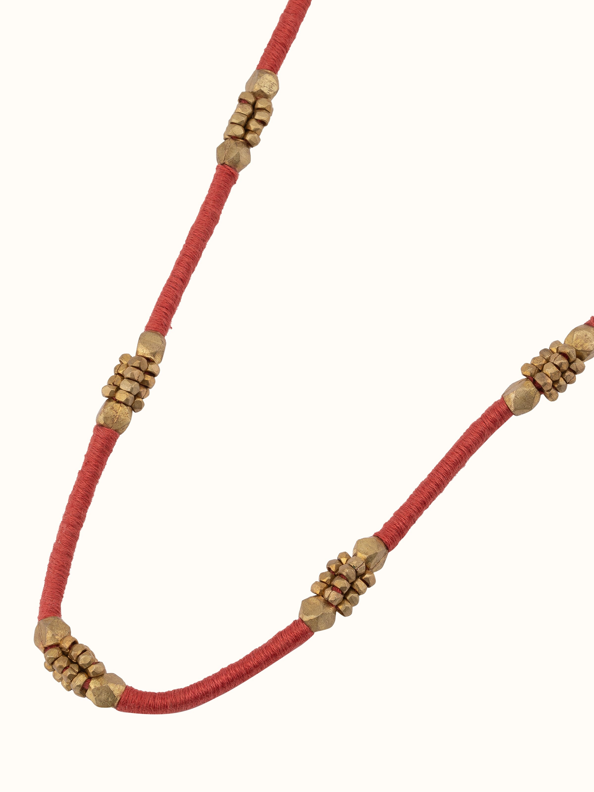 Angled view of Dhokra long necklace focusing on intricate details and tribal design
