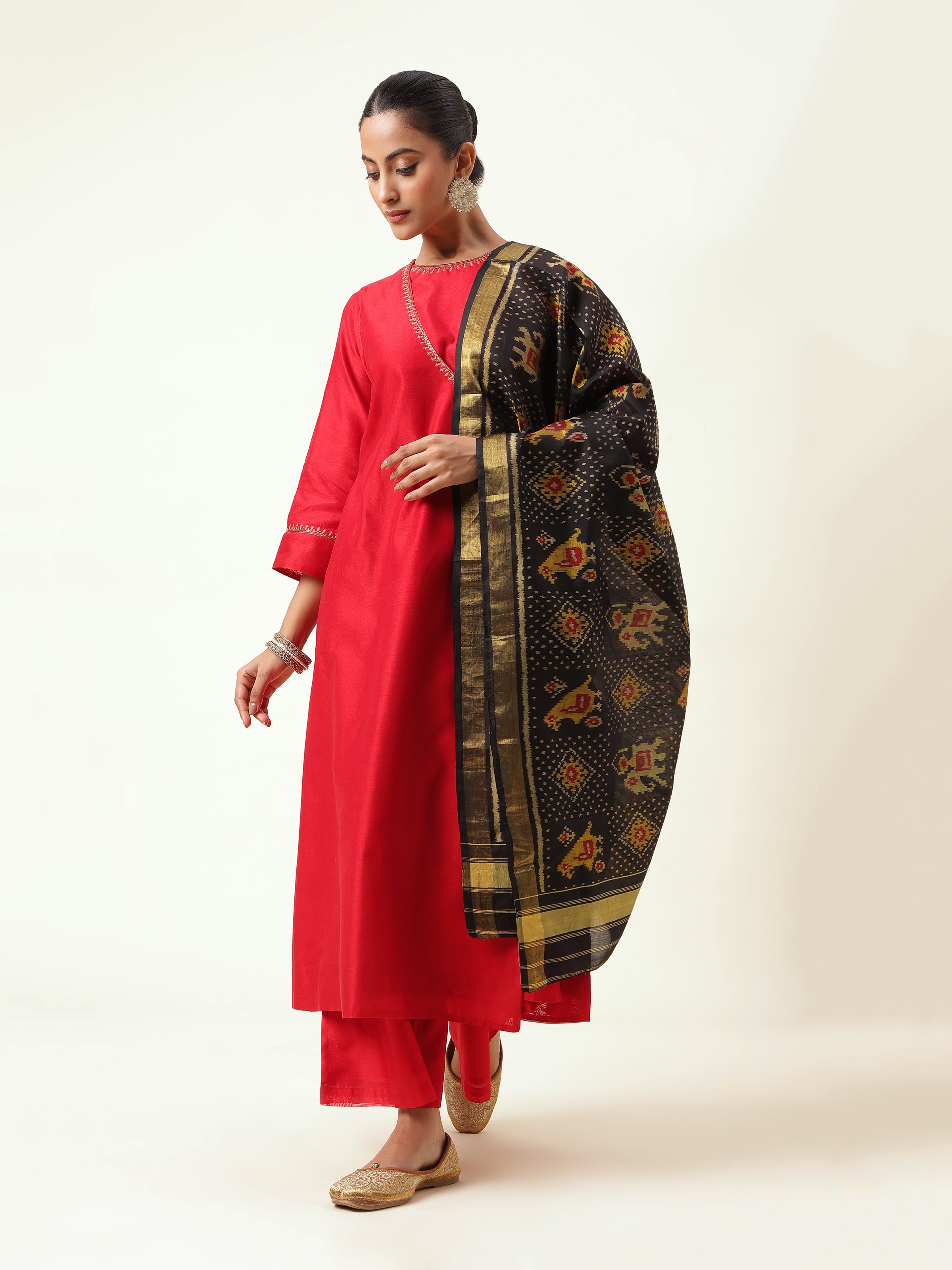 Front angled view of black dupatta showcasing symmetrical Ikat design.