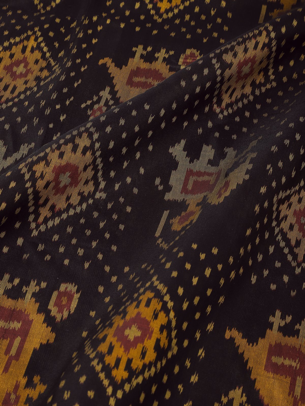 Detail shot showing fine Ikat detailing and silk texture.