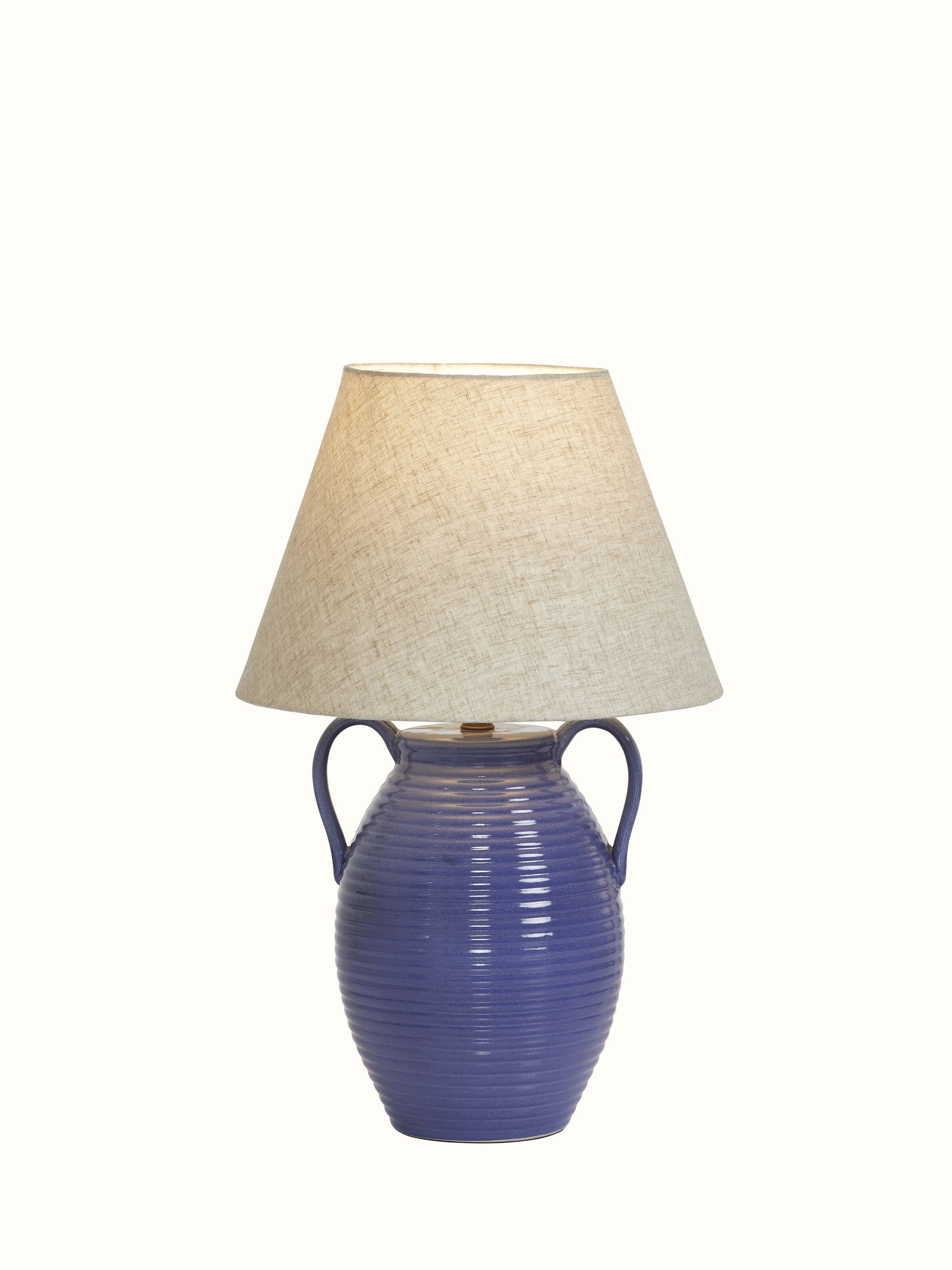 Side view of the off-white studio pottery & cotton table lamp, showing its modern design and soft light diffusion.
