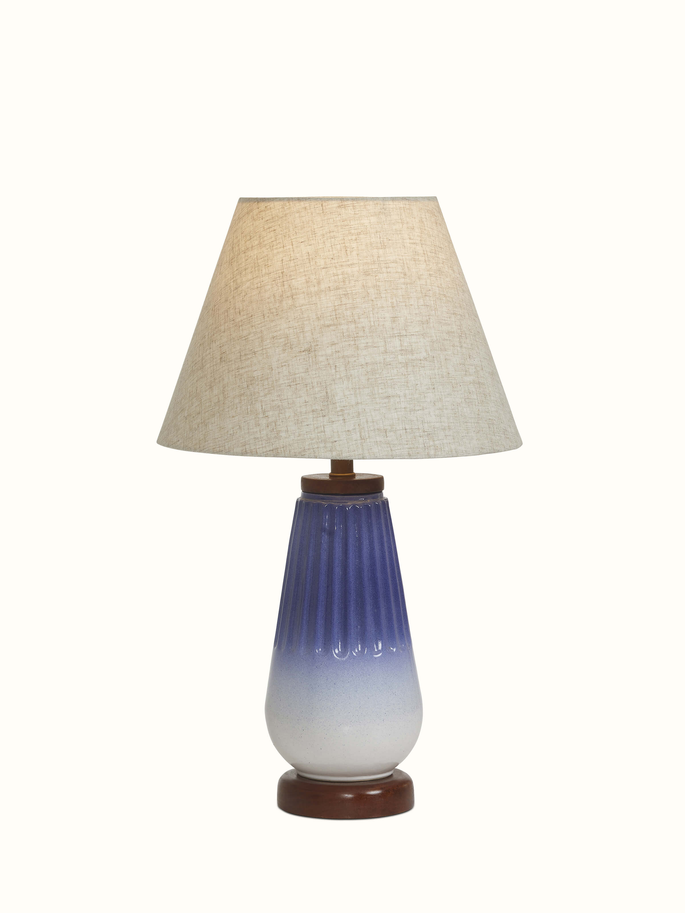 Close-up view of Studio pottery & cotton table lamp in grey color focusing on the details of the pottery and fabric.