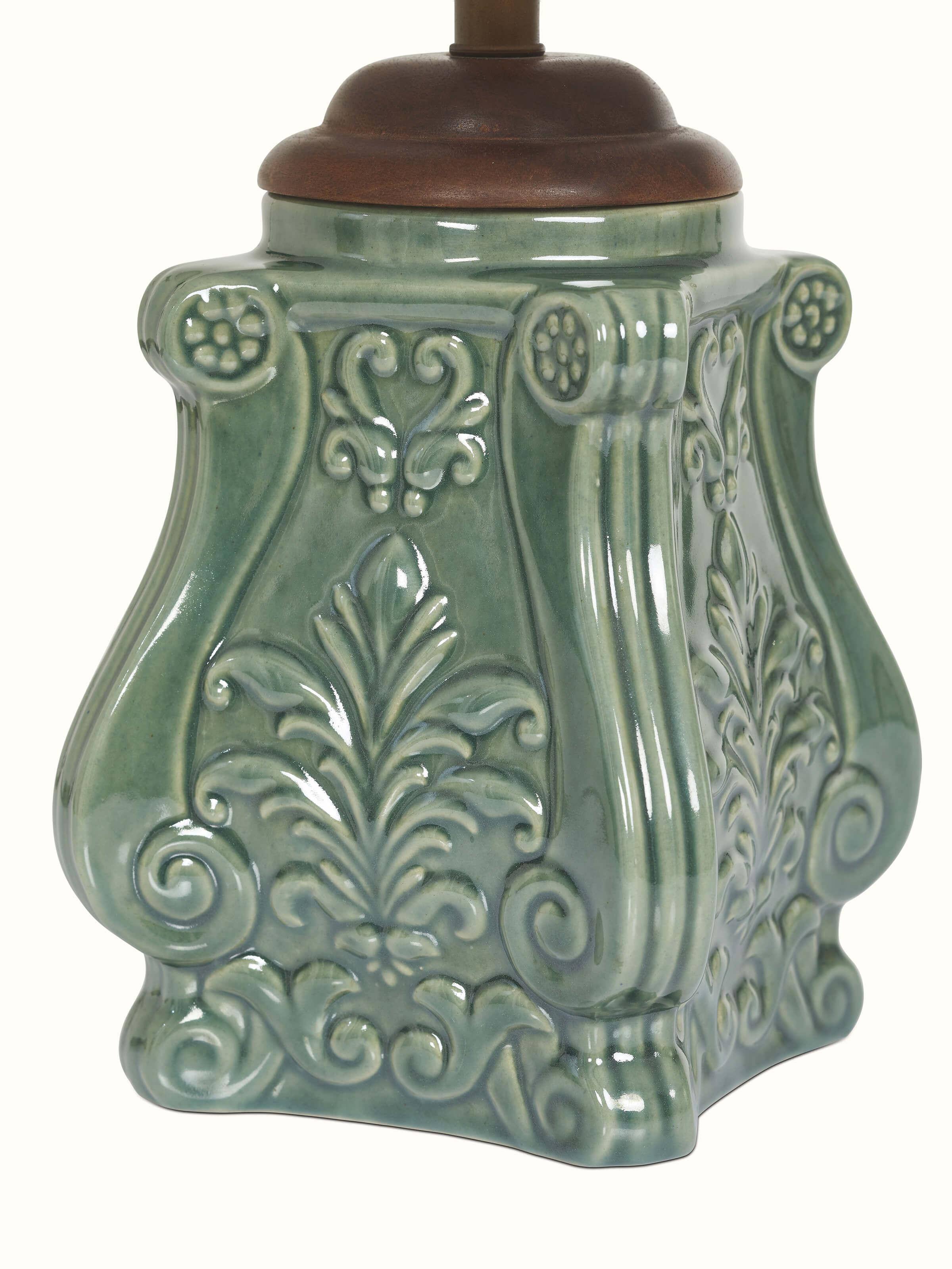 Side view of the studio pottery and cotton LED table lamp, focusing on its blue ceramic base and the soft glow it emits.