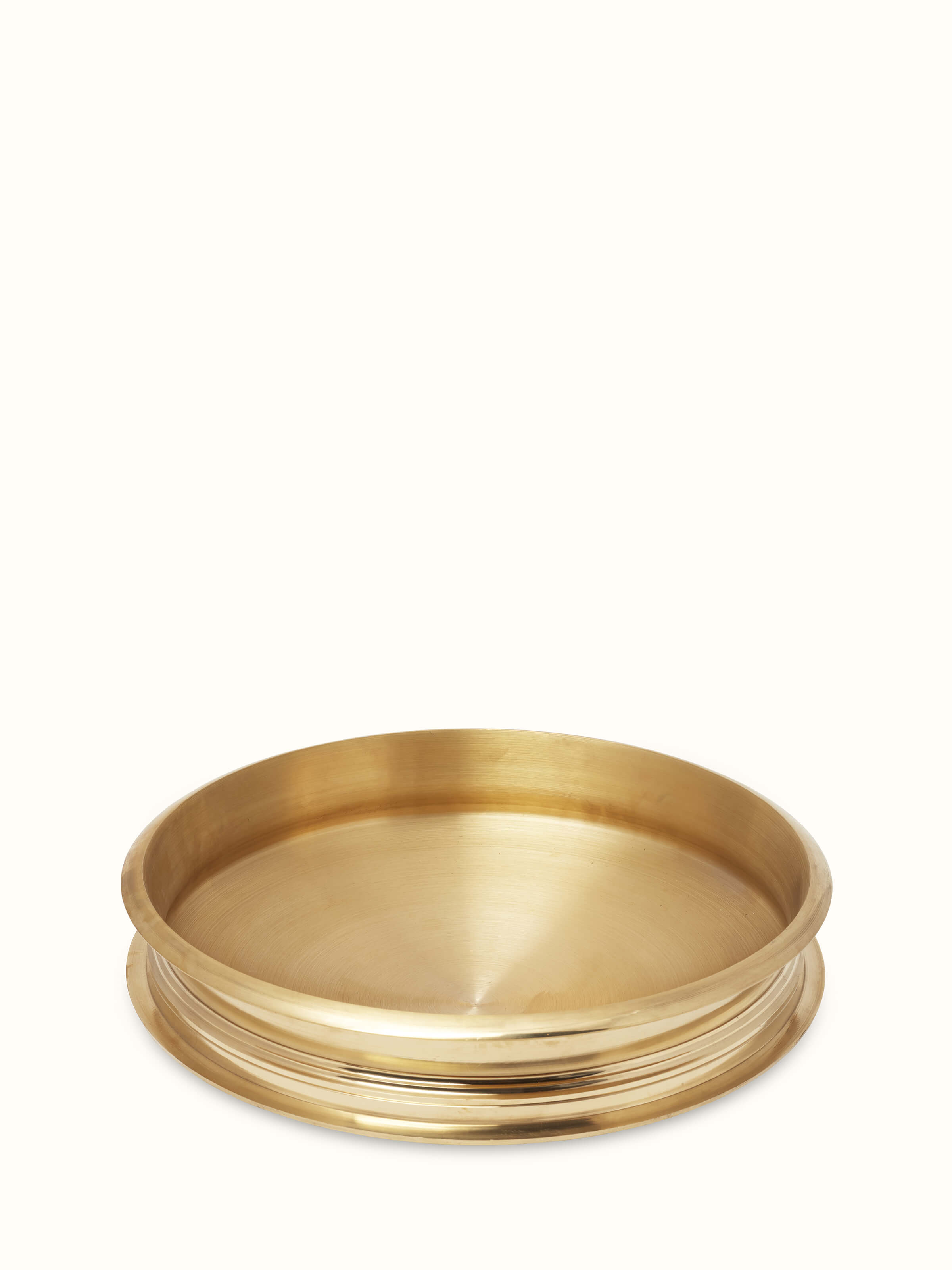 Close-up view of Traditional brass urli focusing on the intricate design and brass quality.