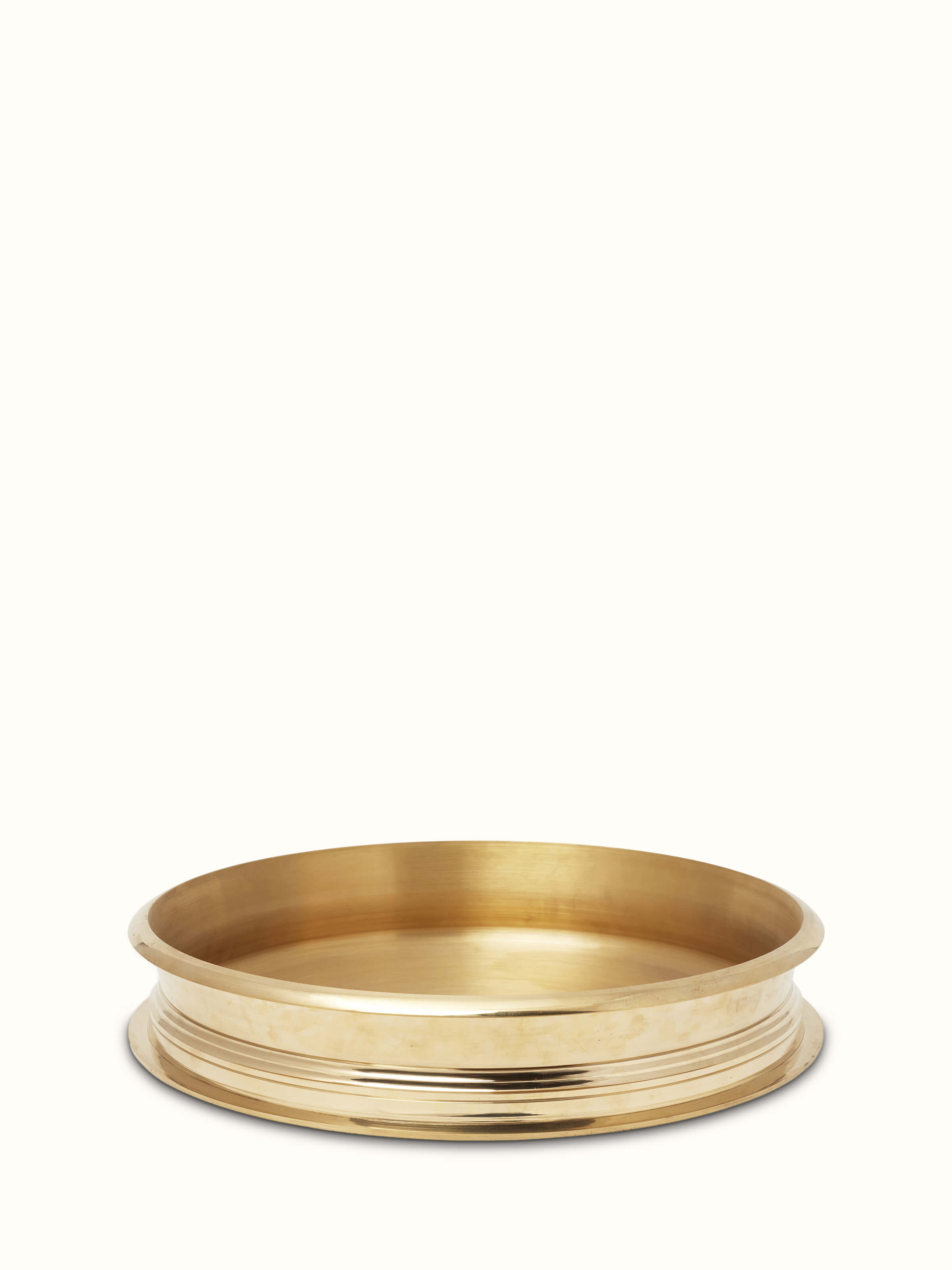 Front view of transitional brass urli with polished finish