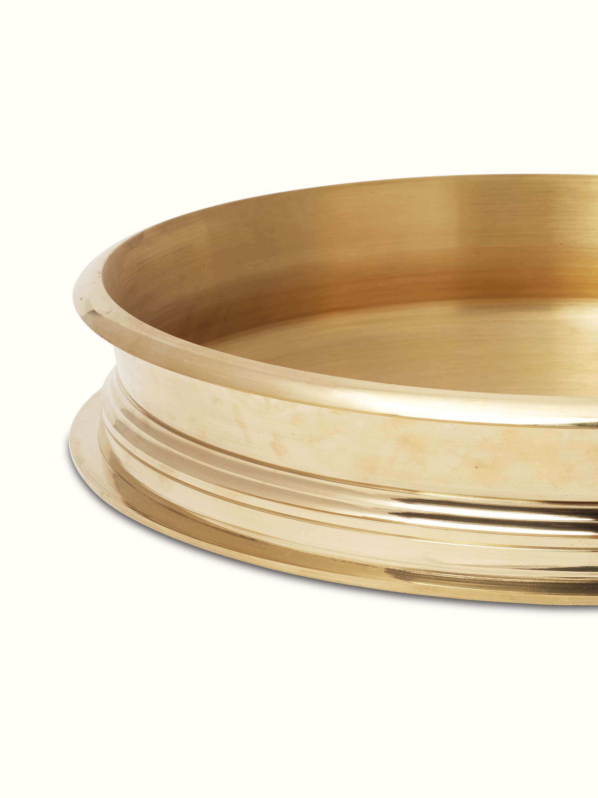 Detailed view of transitional brass urli showcasing its craftsmanship and design