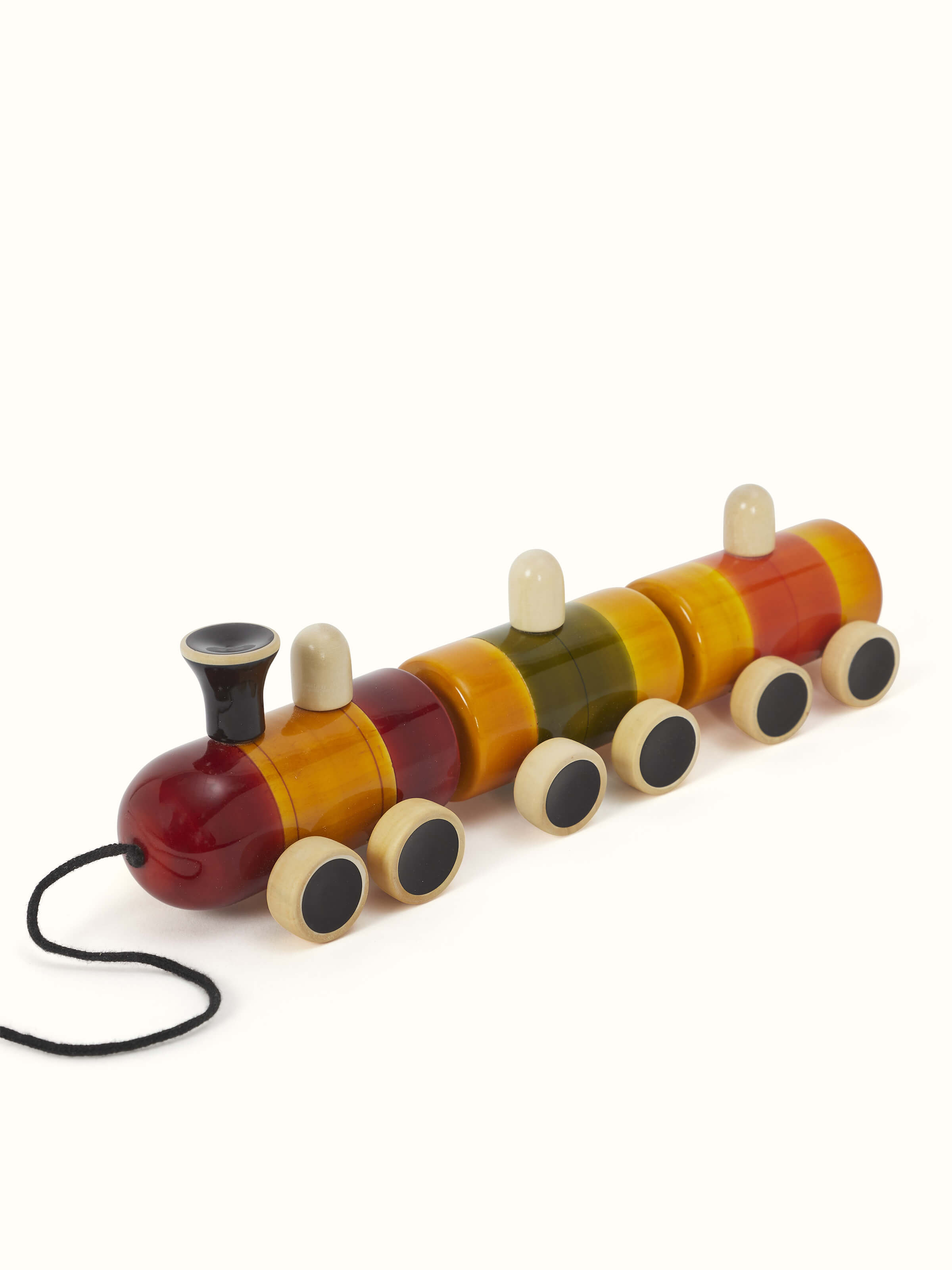 Side view of Channapatna White Wood Pom Pom Rail Toy highlighting intricate woodwork and playful pom-poms