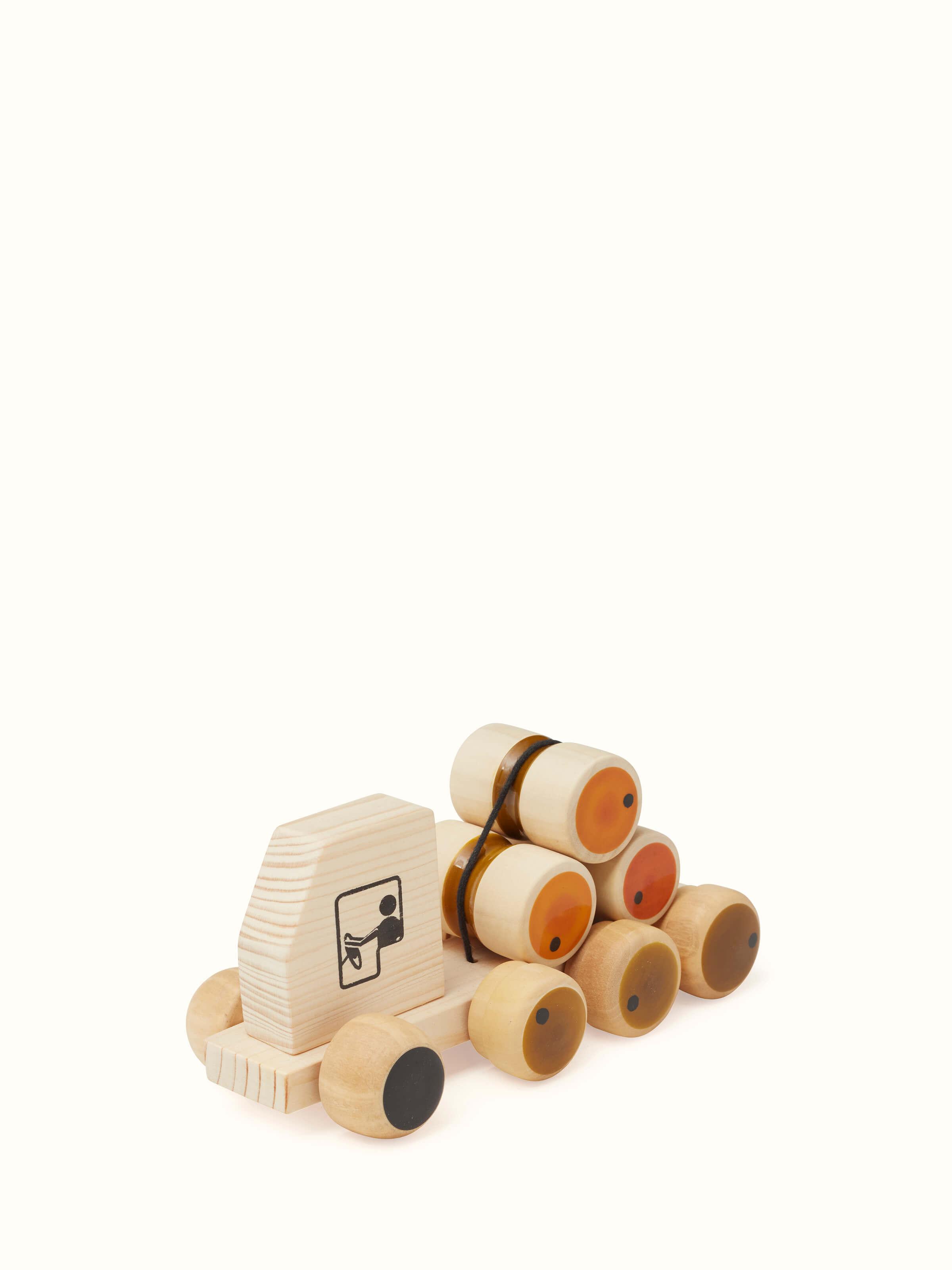 Side view of Channapatna Wooden Rumbelorry Toy highlighting detailed wooden design and playful appearance.