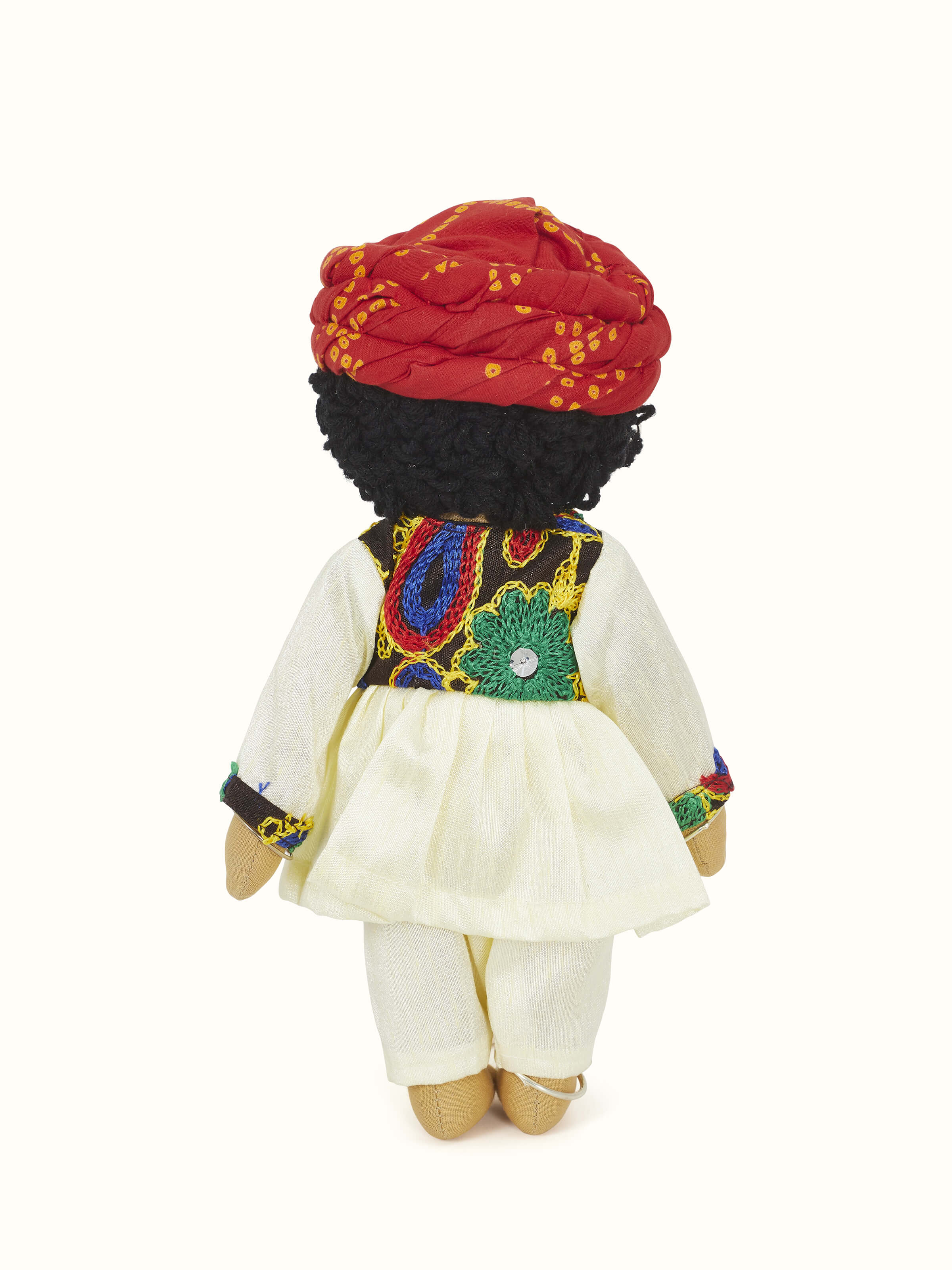 Side view of Crocheted cotton Rajasthani boy soft toy highlighting its handcrafted details and cheerful appearance