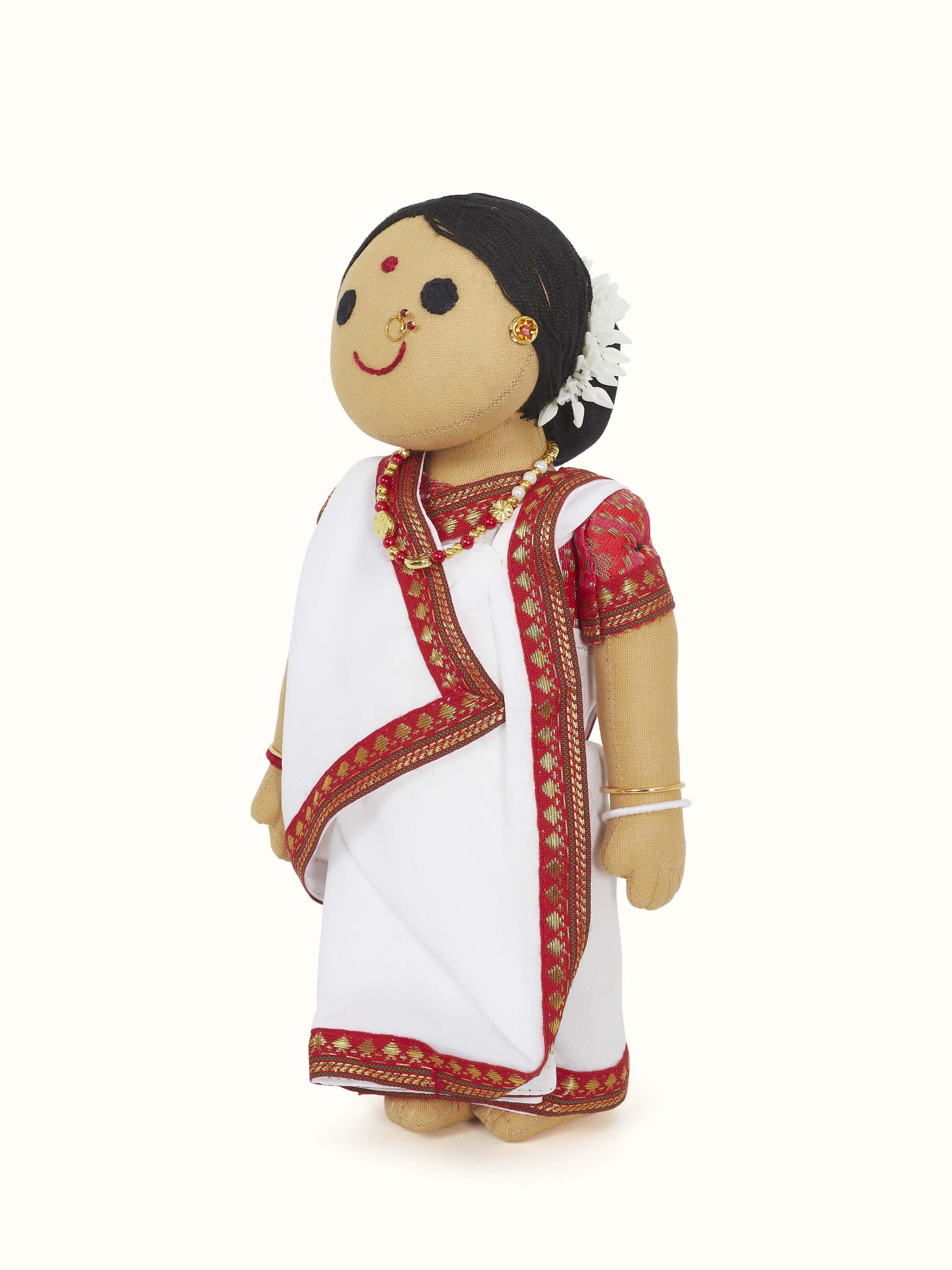 Close-up view of the crocheted cotton Bengali girl soft toy, highlighting facial features and attire.