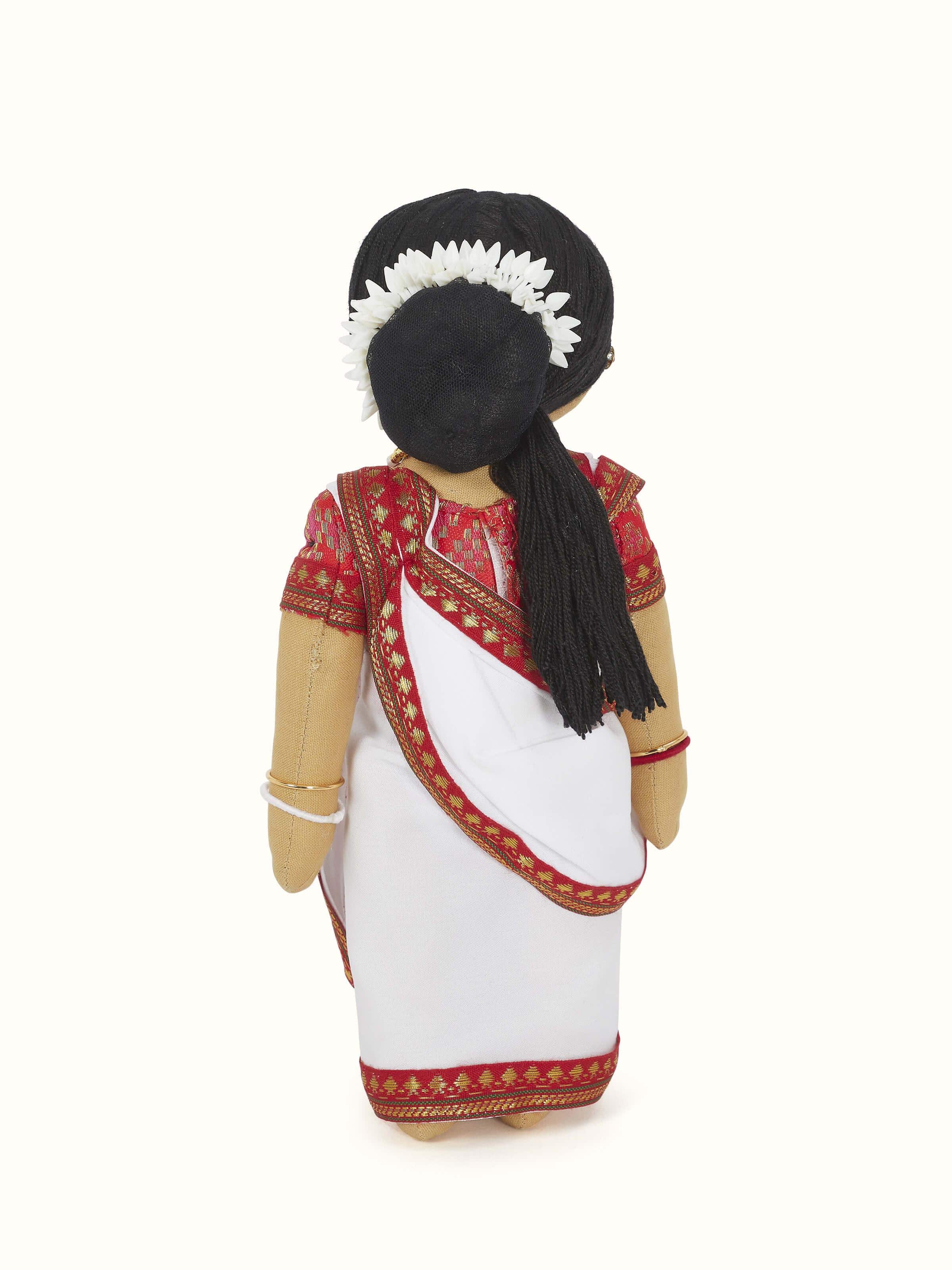 Side view of the crocheted cotton Bengali girl soft toy, showcasing the detailed crochet patterns and soft texture.