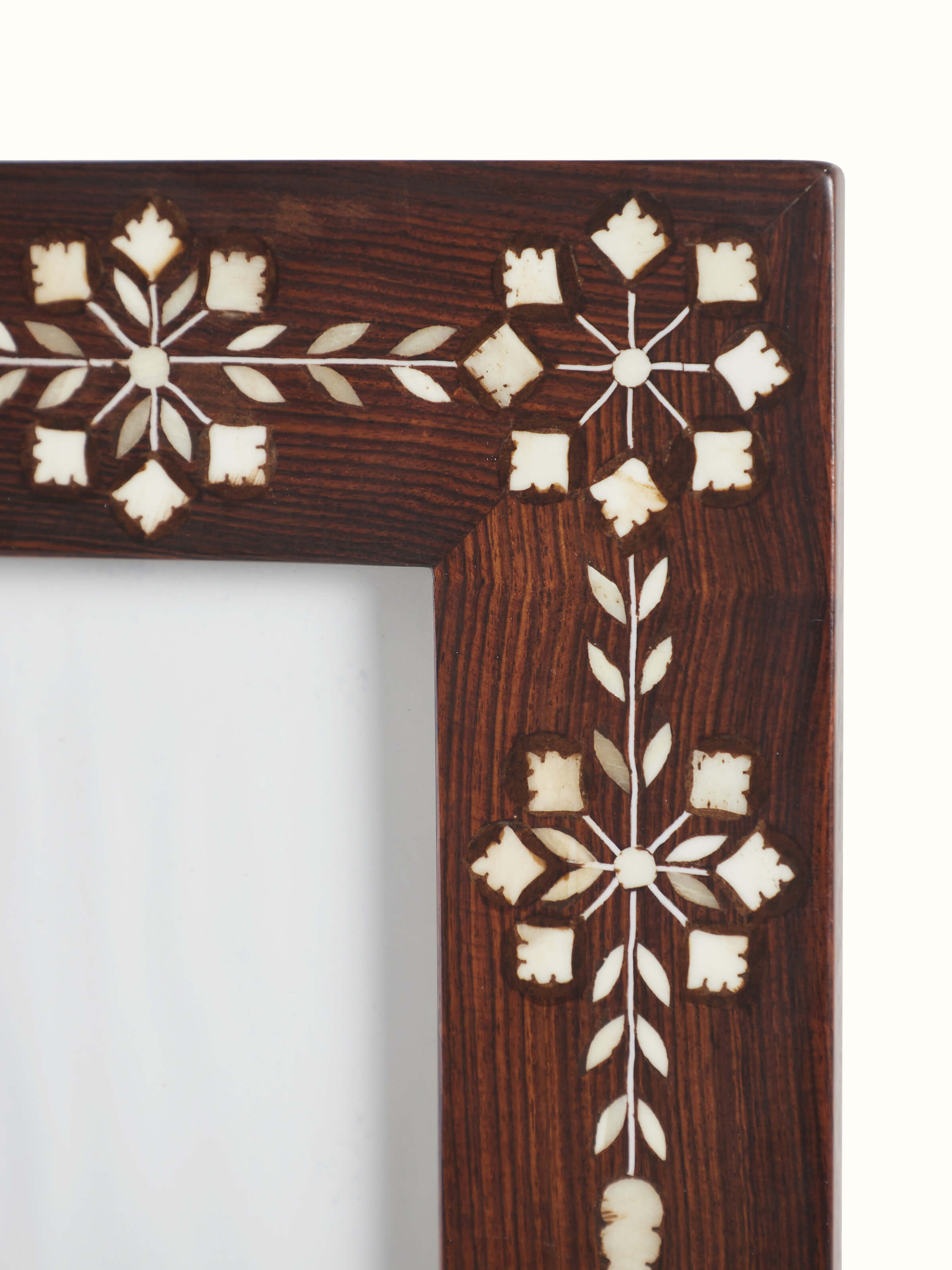 Detailed view of the sheesham wood and bone inlaid photo frame, highlighting the texture and artistic inlay work.