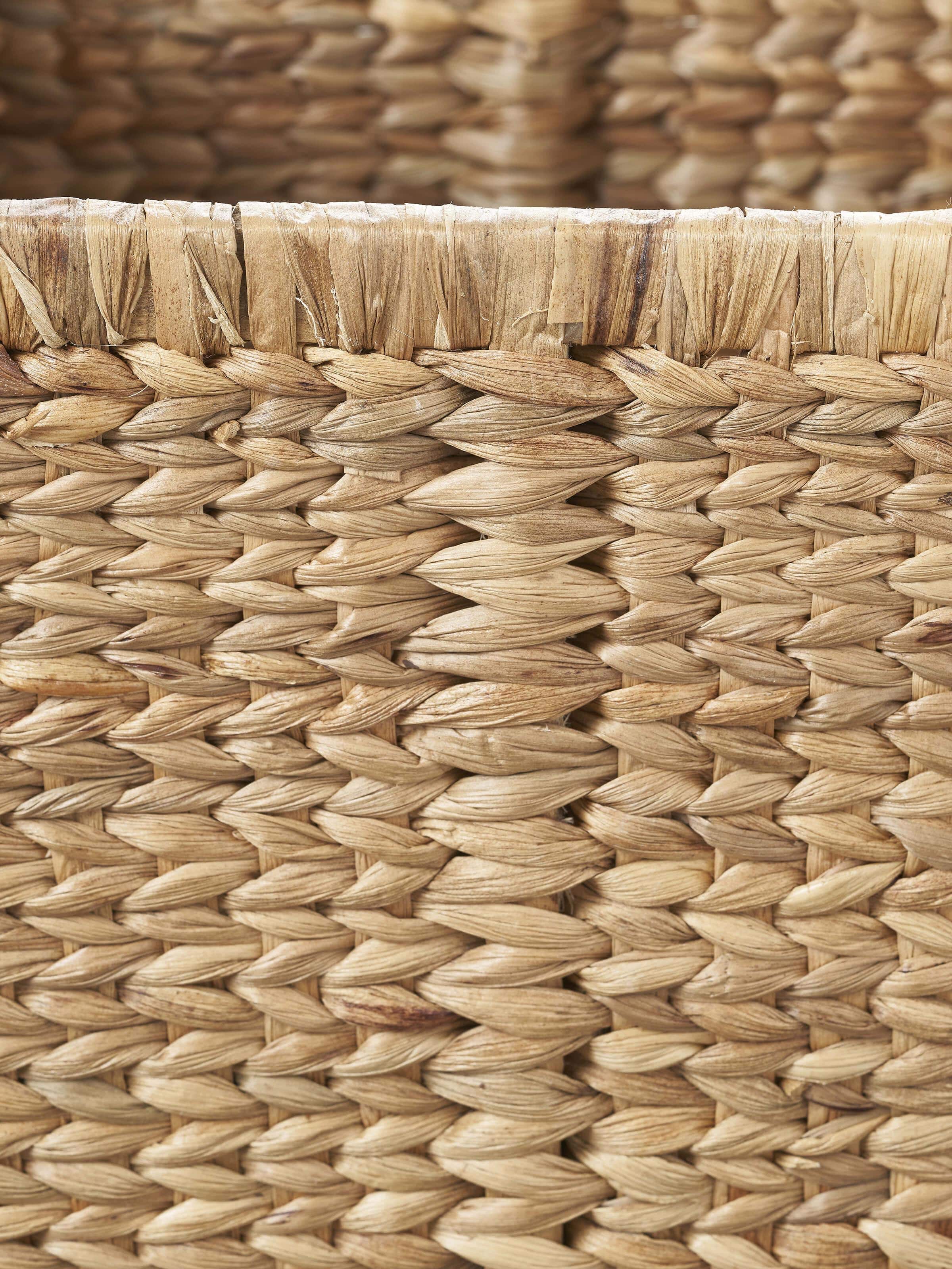 Angled view of traditional natural water hyacinth fibre storage organiser, focusing on the intricate weave and natural fibers.