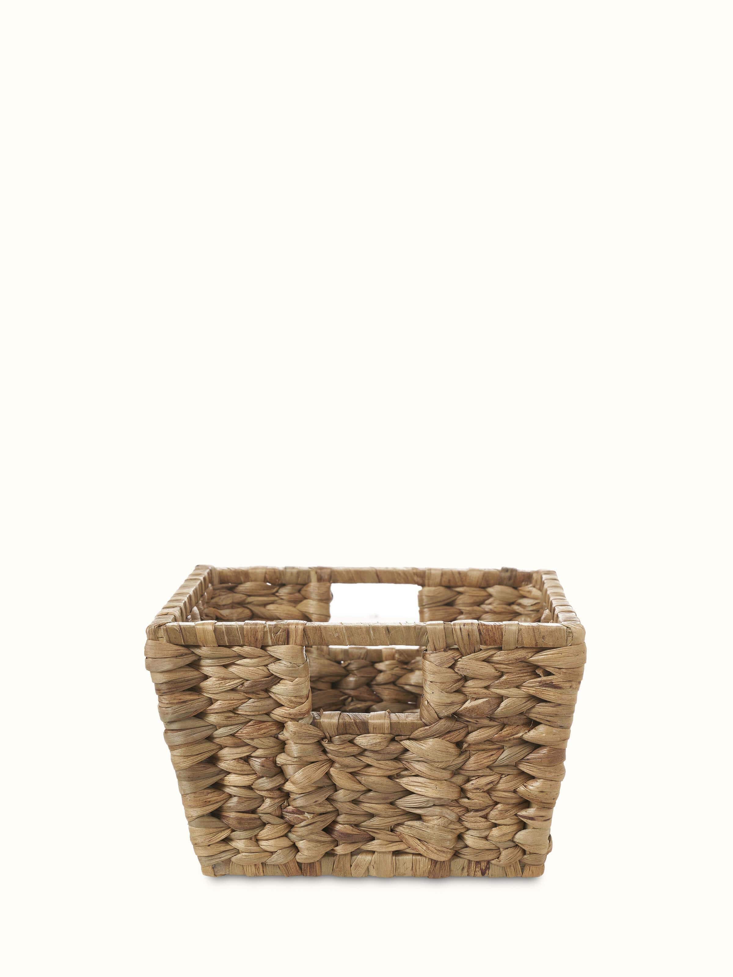 Natural water hyacinth fibre storage organiser with a woven texture and open design, ideal for home organization.
