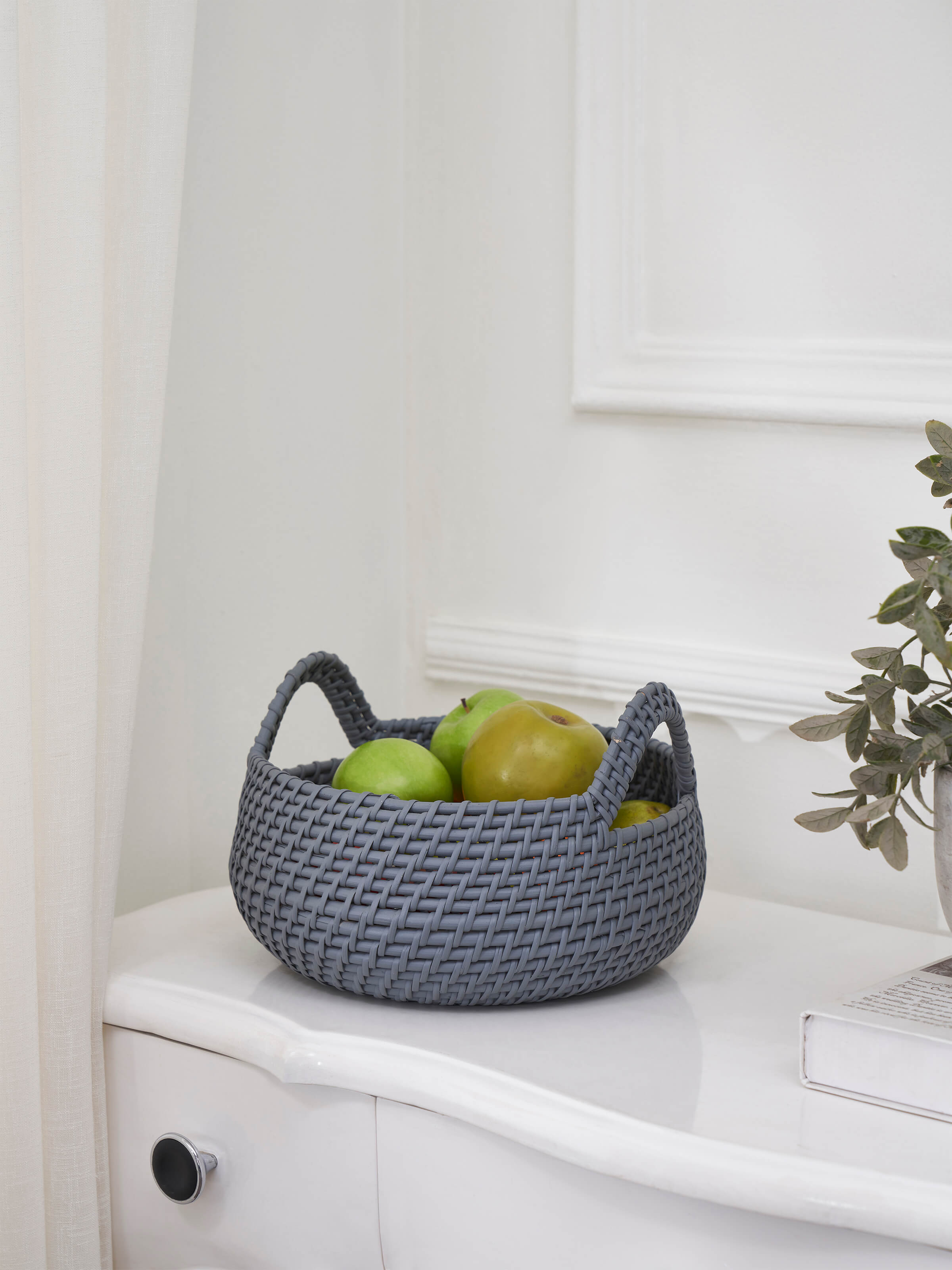 Side view of Cane decorative apple basket in grey color showcasing the detailed weaving and handle.