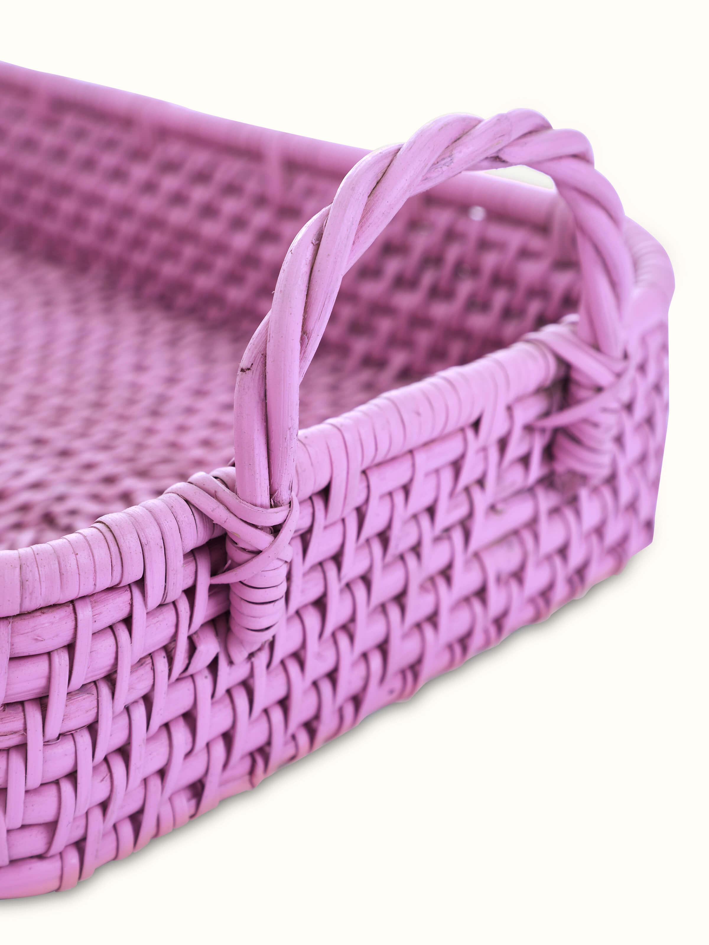 Close-up view of cane storage organiser in pink color, highlighting the fine details and texture of the cane material