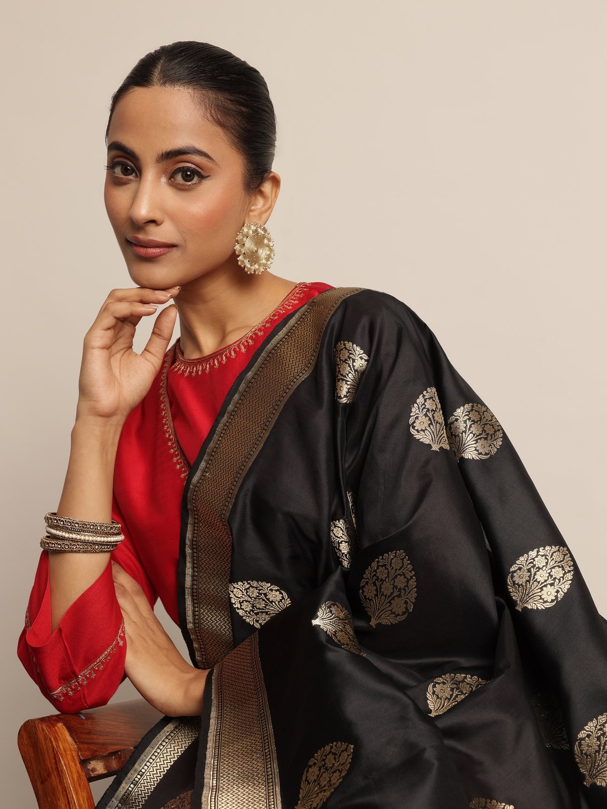 Close-up of black Banarasi dupatta on model highlighting traditional weaving and ornate zari detailing.