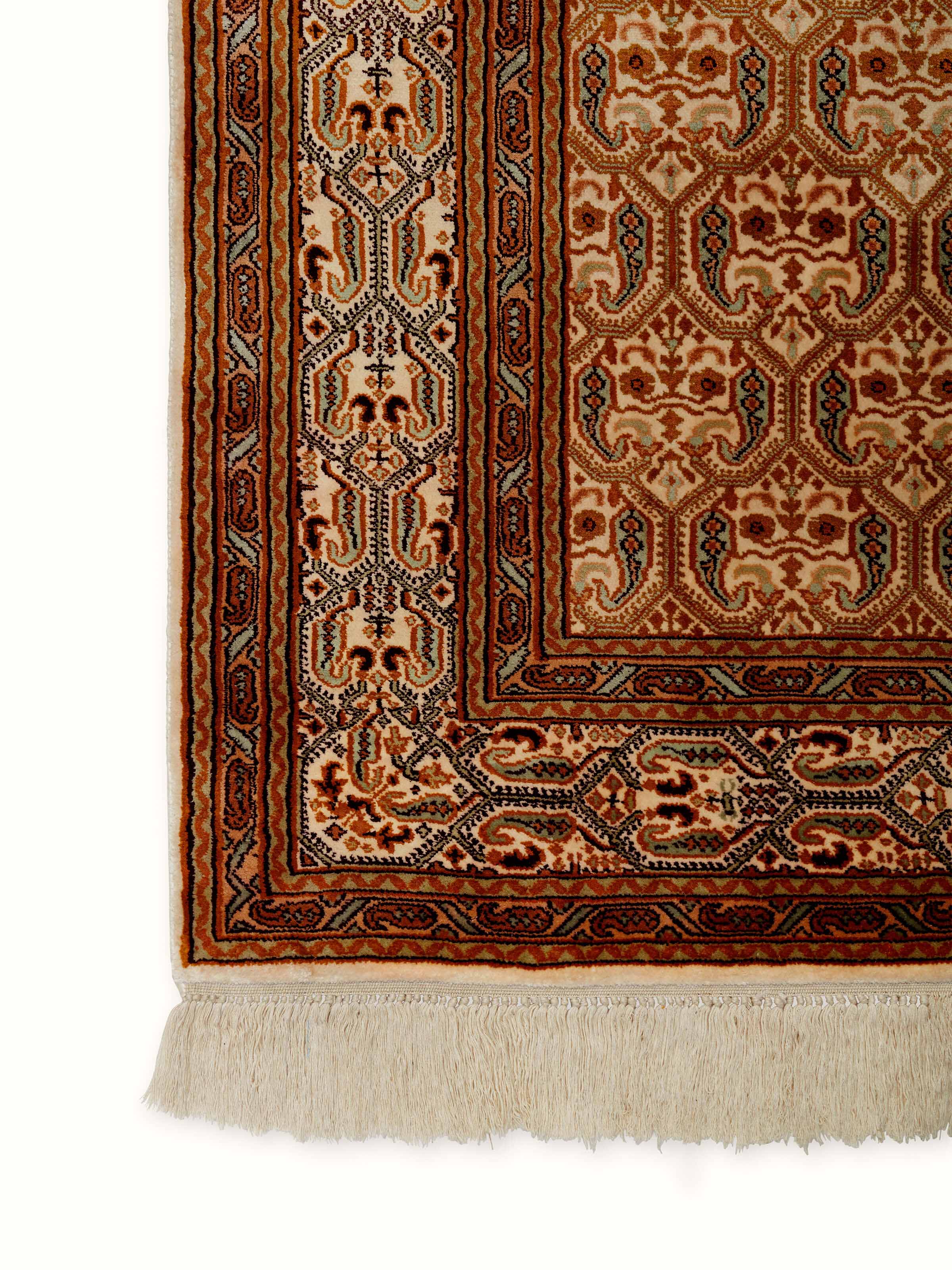 Detailed side view of Traditional Persian Ivory Senna Kashmir Silk Hand-Knotted Carpet showcasing the elegant border and intricate motifs