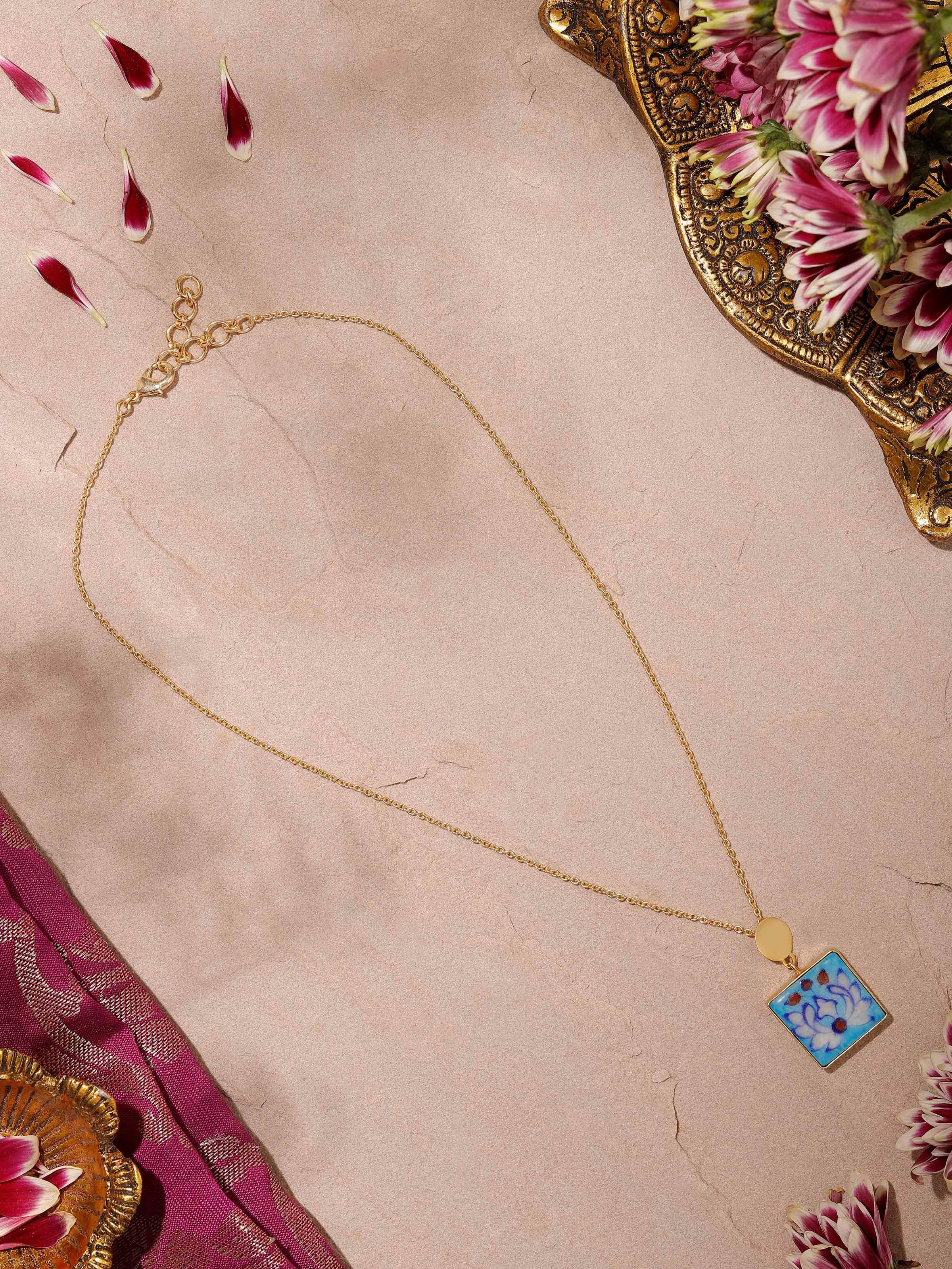 Side view of Blue Pottery Pendant & Chain showcasing the detailed pottery work and sleek chain design