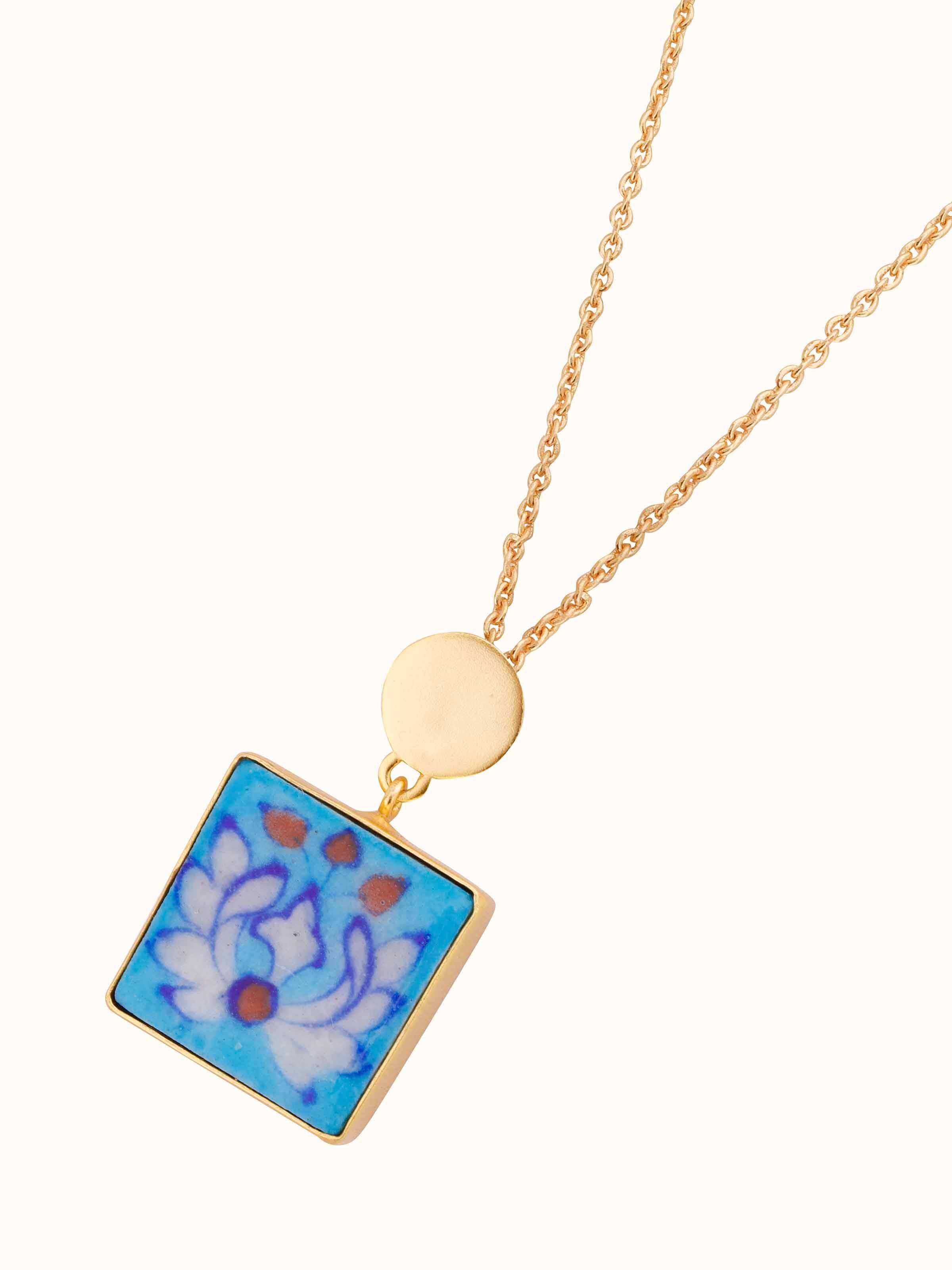 Angled view of Blue Pottery Pendant & Chain showcasing its unique pottery design and elegant chain