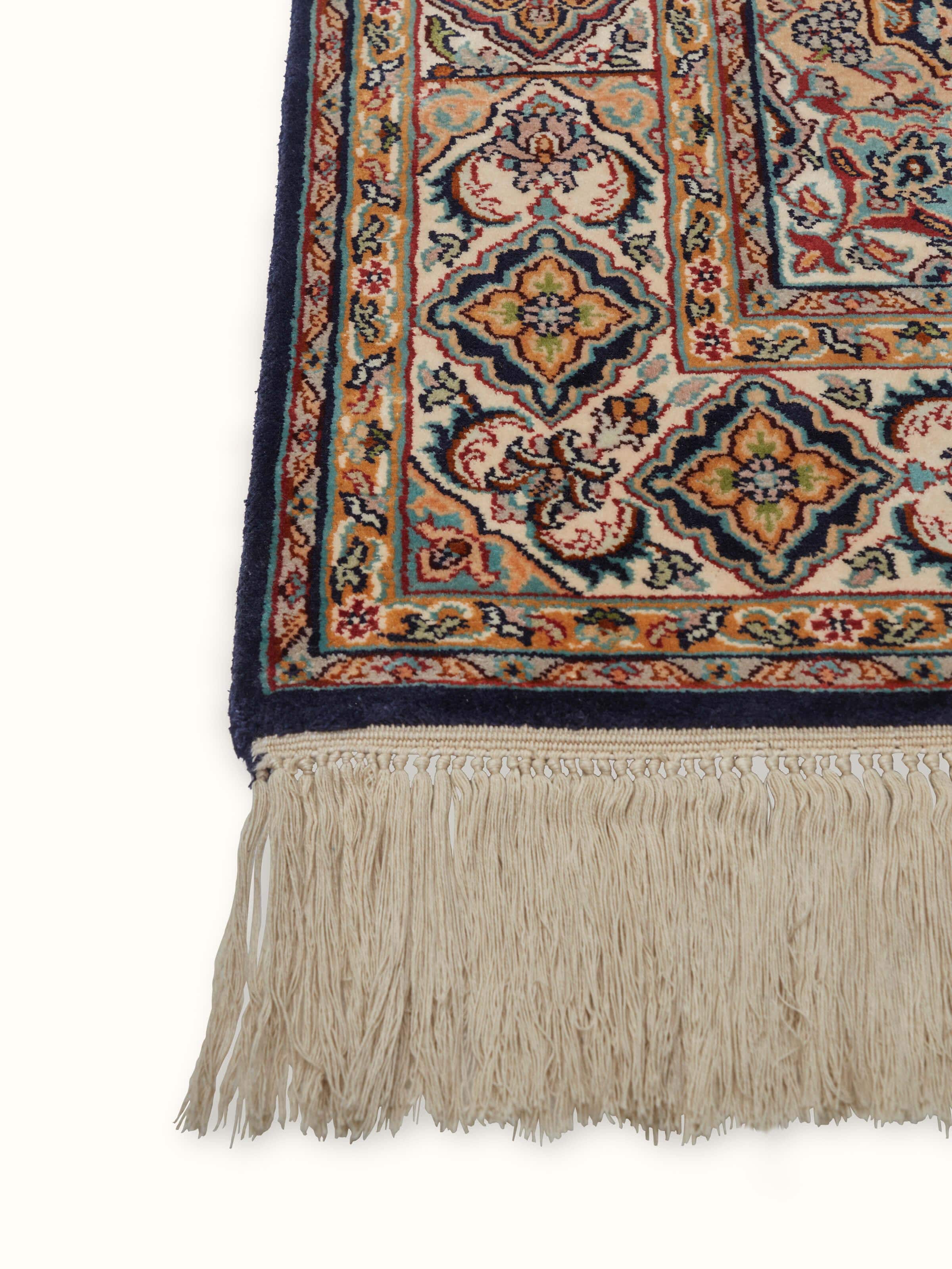 Angled view of Traditional Persian Sadakdar Kashmir silk hand-knotted carpet displaying its luxurious fabric and design