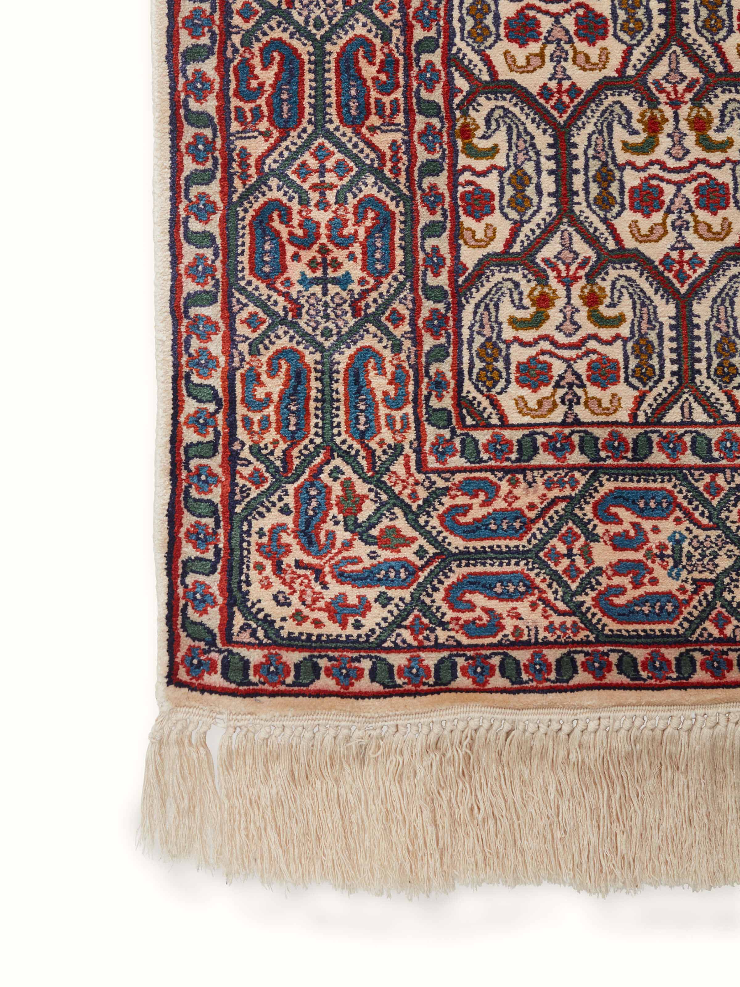 Detailed view of the edges and knots of a traditional Persian silk carpet from Kashmir, highlighting the meticulous craftsmanship.