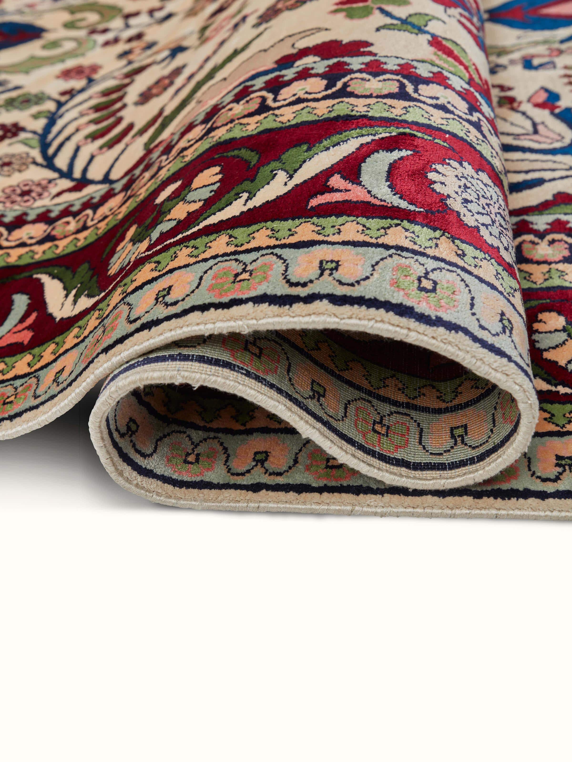 Close-up of Traditional Persian Isfahan Kashmir silk hand-knotted carpet focusing on detailed craftsmanship