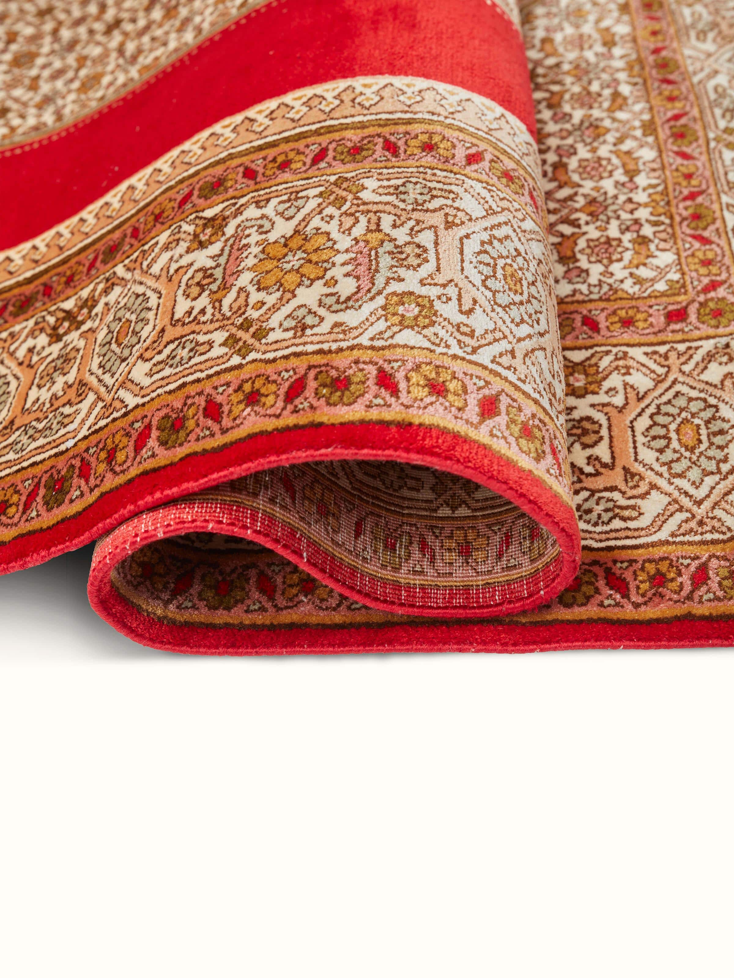 Detailed view of Traditional Persian Red Senneh Kashmir Silk Hand-Knotted Carpet showing intricate patterns and silk sheen.