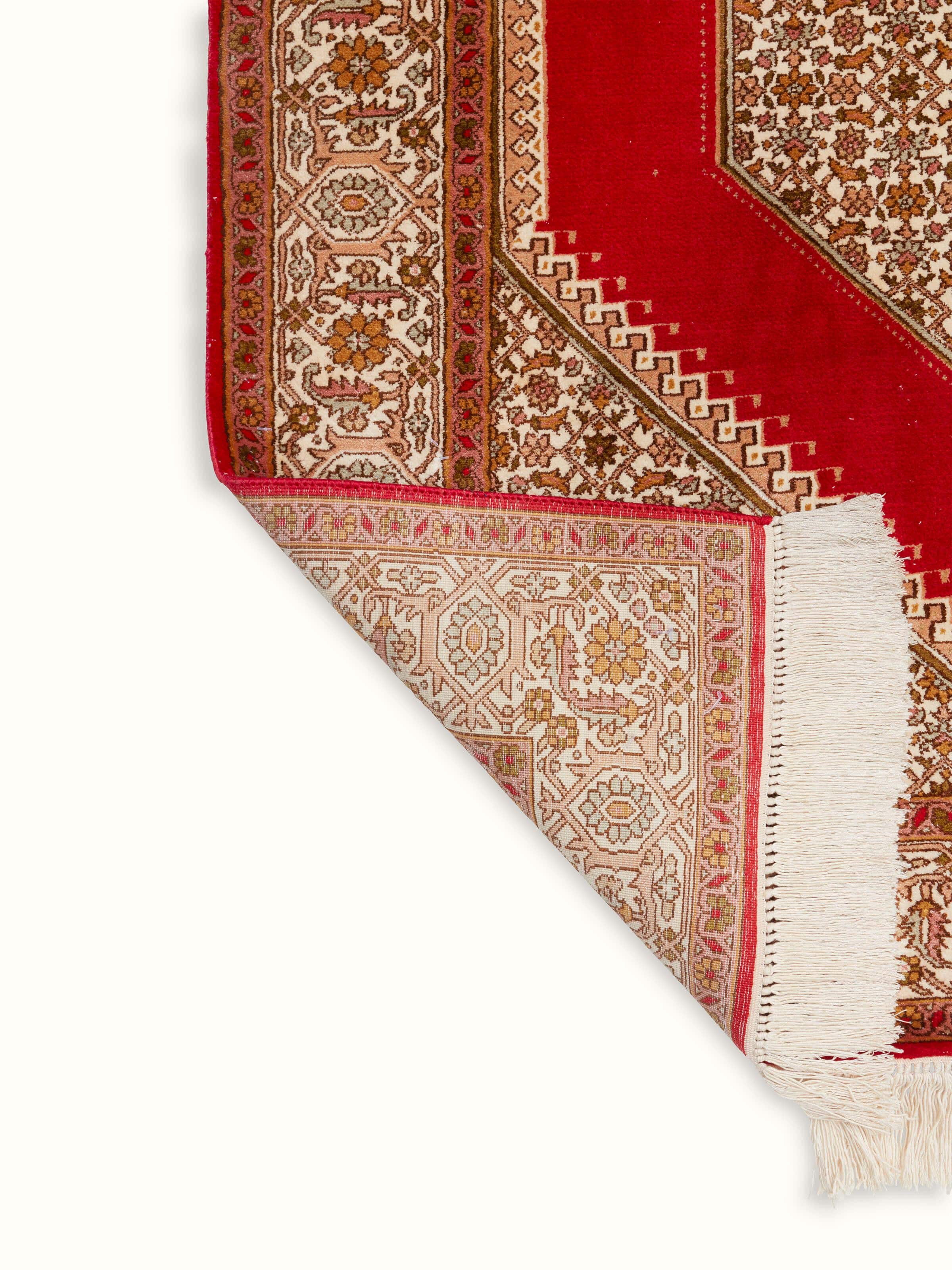 Full view of Traditional Persian Red Senneh Kashmir Silk Hand-Knotted Carpet laid out, showcasing its size and design in a setting.