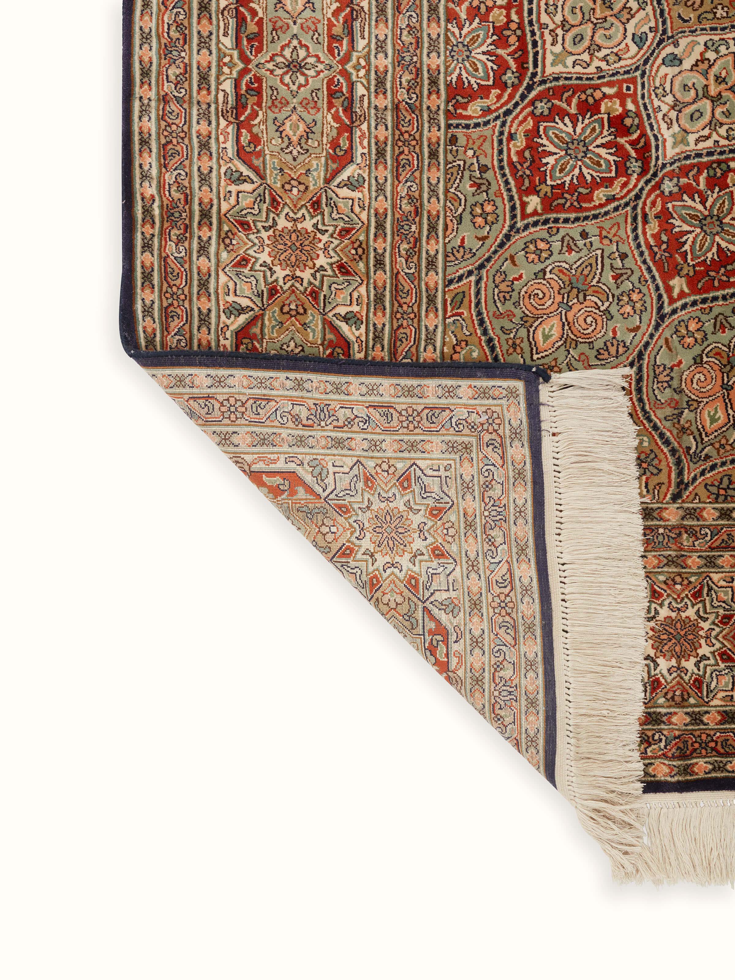 Detailed view of Traditional Persian rust gumbad Kashmir silk hand-knotted carpet, focusing on the carpet’s ornate patterns and color variations.