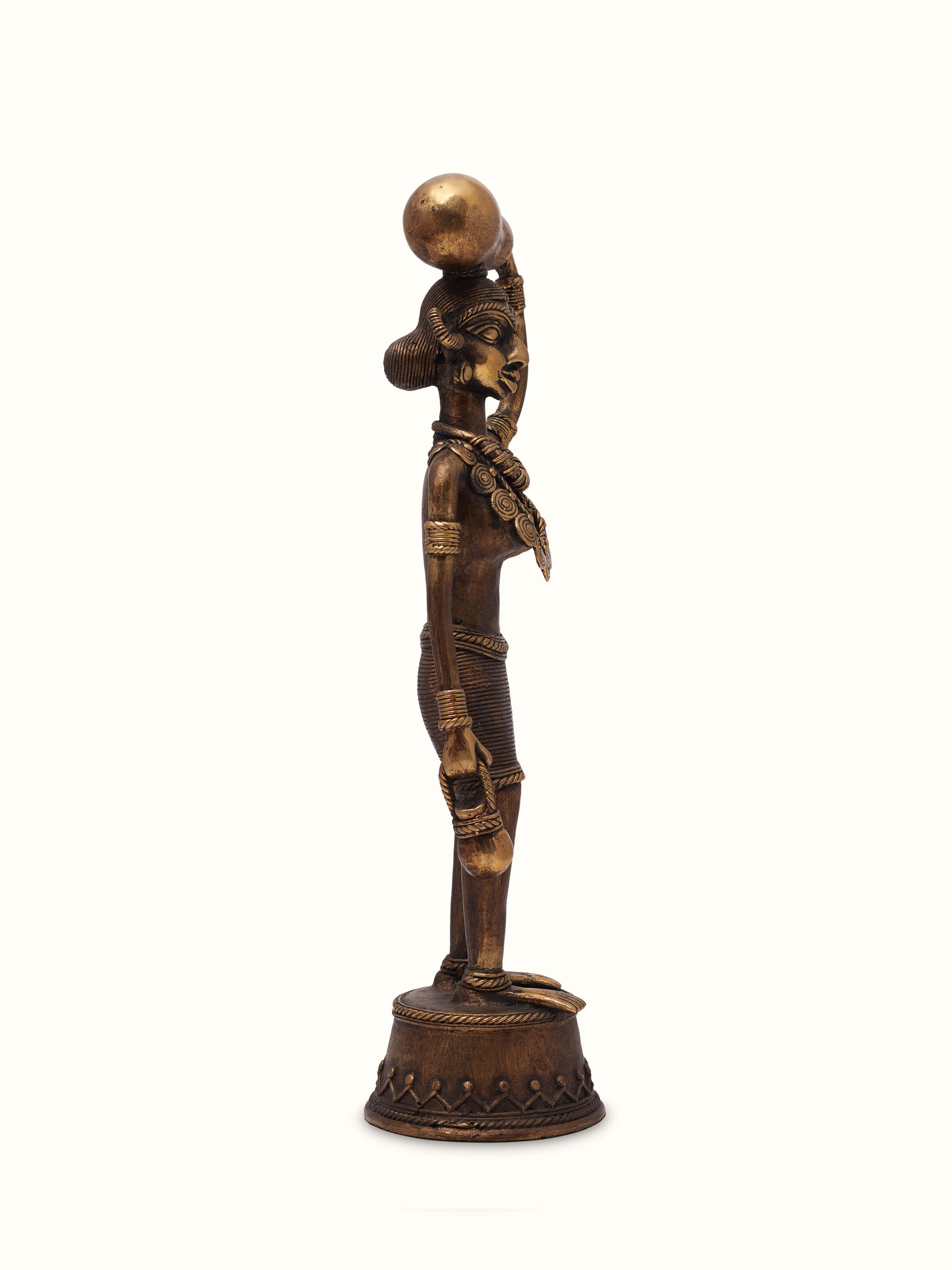 Angled view of Dhokra Brass Tribal Woman Figurine, showcasing the artistic design and detailed brass figure of a tribal woman.