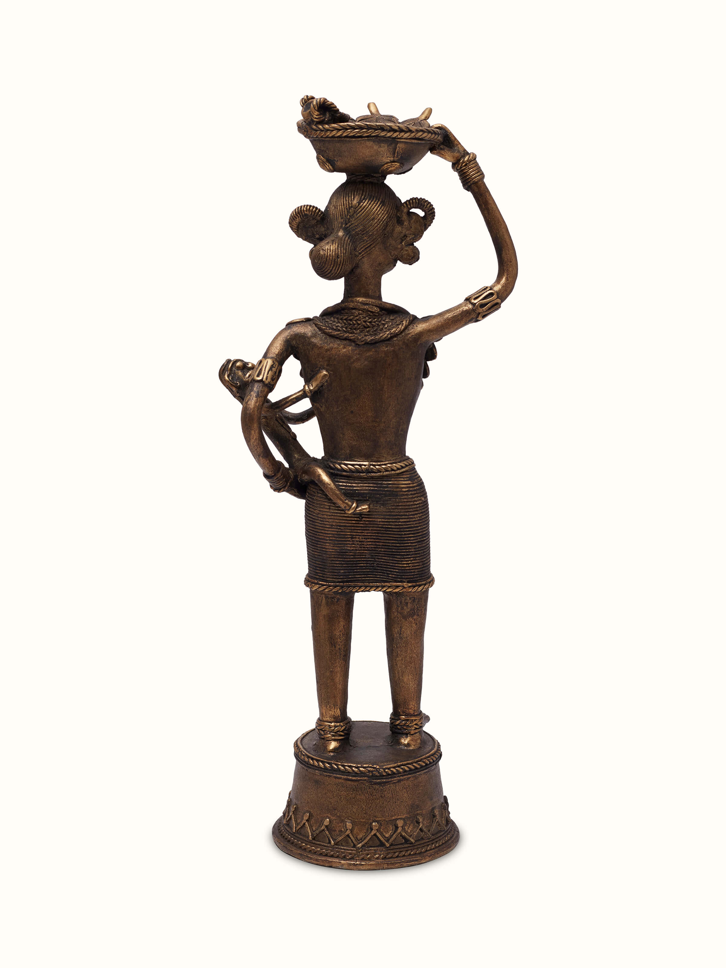 Rear view of Dhokra Brass Tribal Mother Artpiece, capturing the artistic representation of tribal mother in brass.