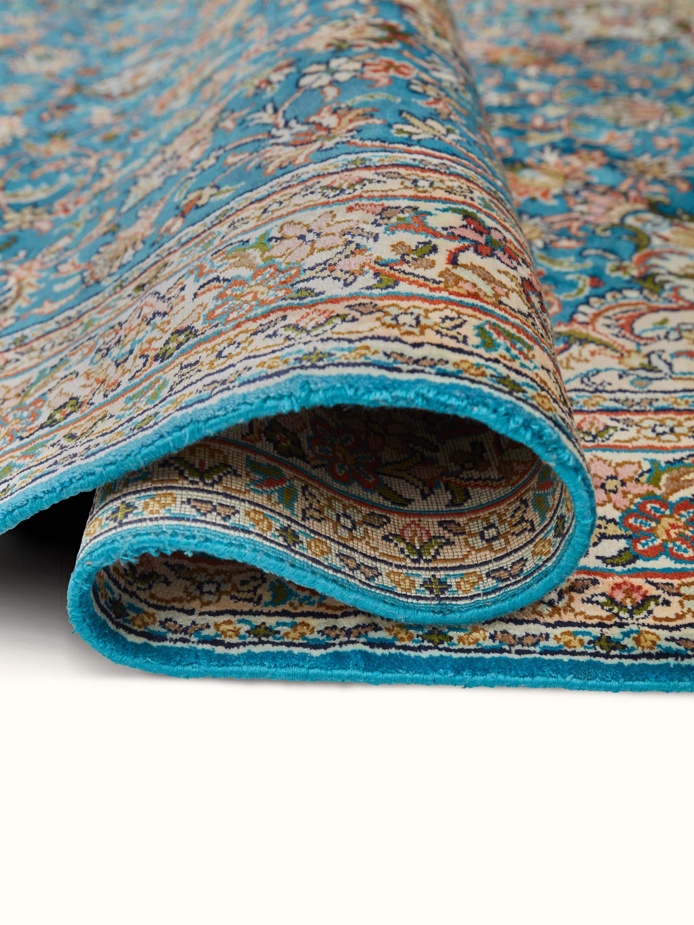 Close-up of Traditional Persian Blue Kashan Kashmir Silk Hand-Knotted Carpet emphasizing fine silk texture and patterns