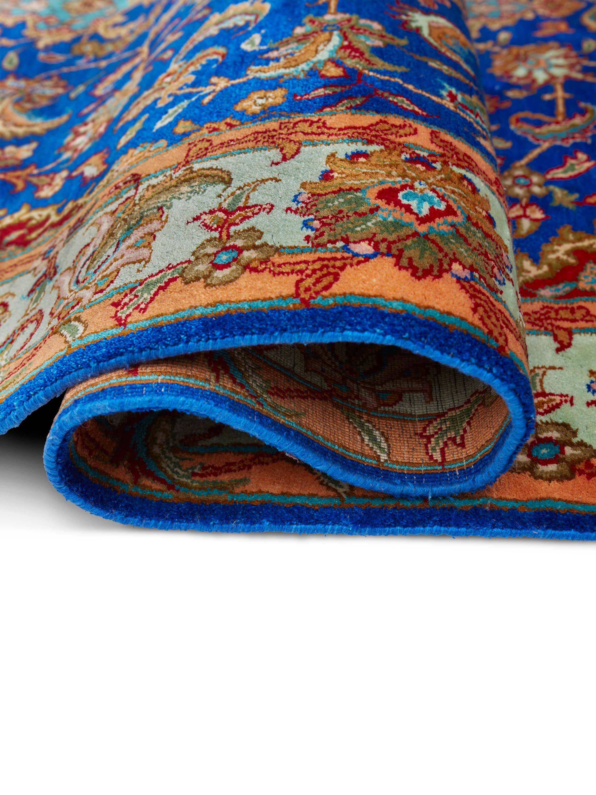 Close-up of Traditional Persian Blue Red Kashan Kashmir silk hand-knotted carpet, focusing on the intricate patterns and rich colors.