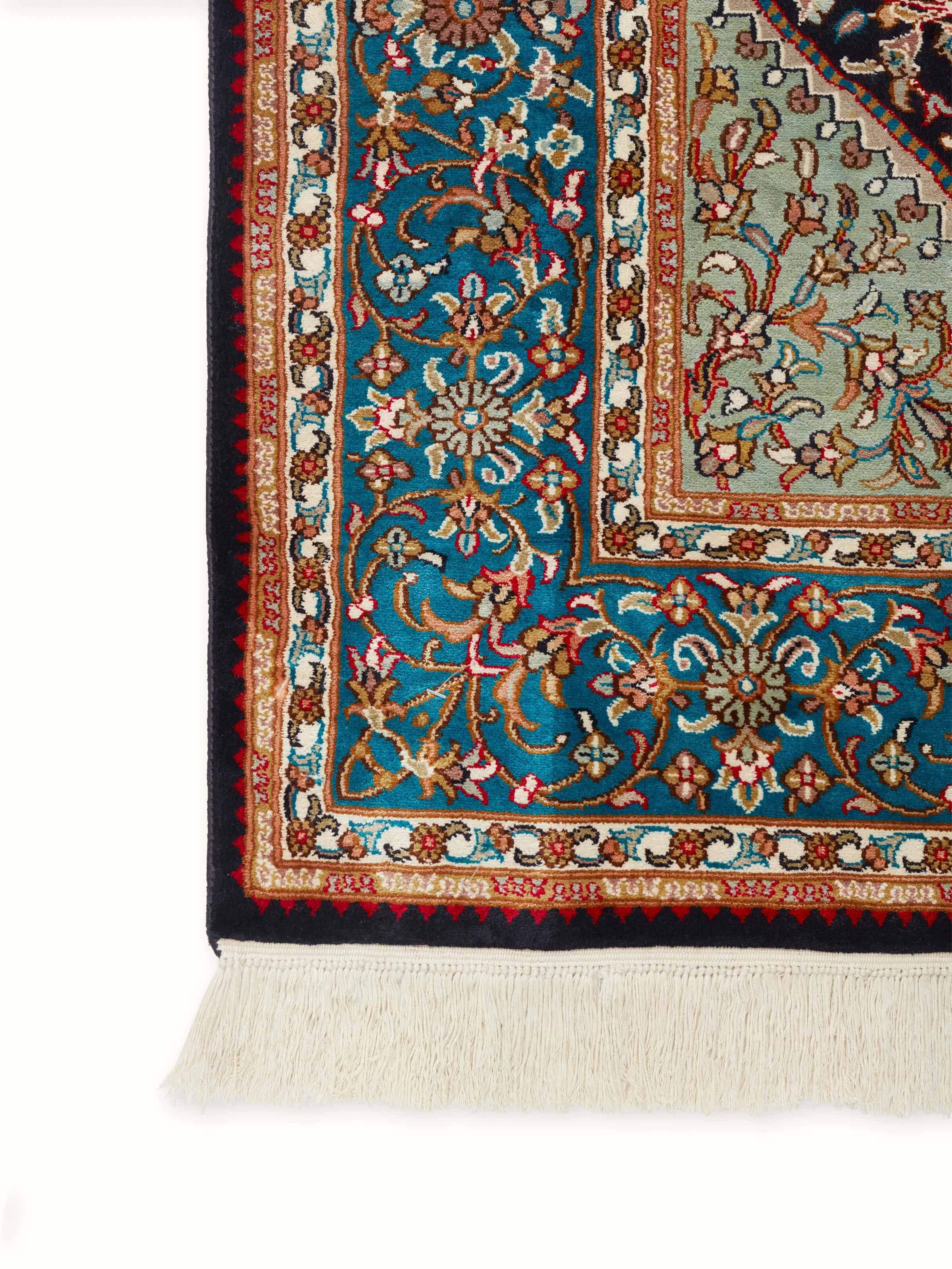 Perspective view of Traditional Persian navy teal Kashan Kashmir silk hand-knotted carpet showing the full design and craftsmanship.