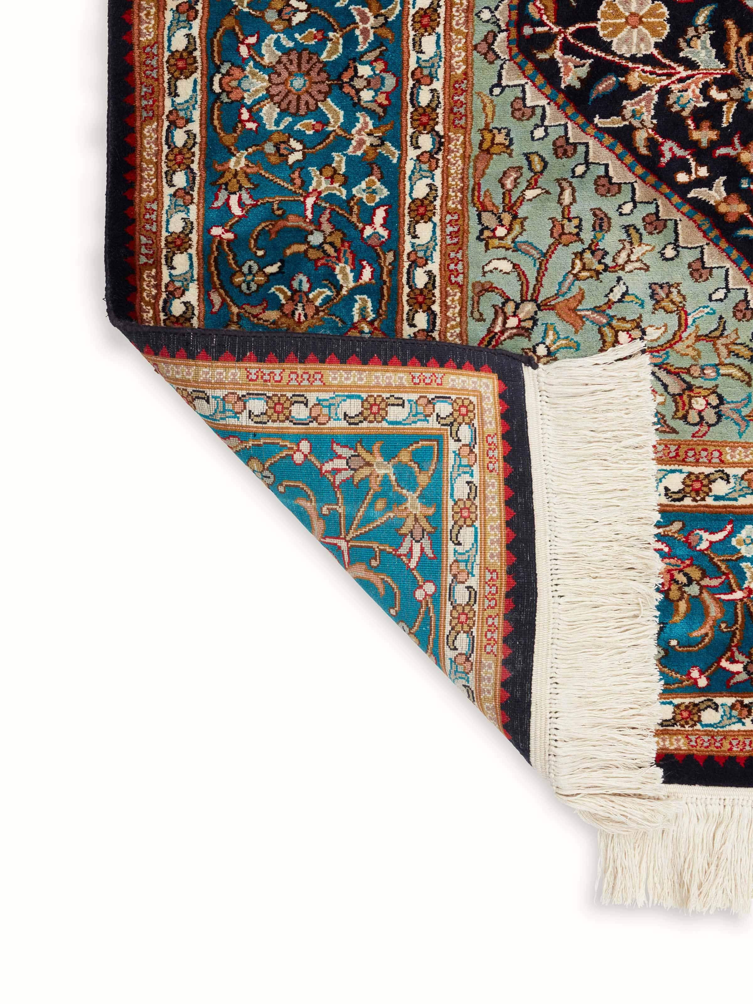 Full view of Traditional Persian navy teal Kashan Kashmir silk hand-knotted carpet emphasizing its luxurious silk and detailed pattern.