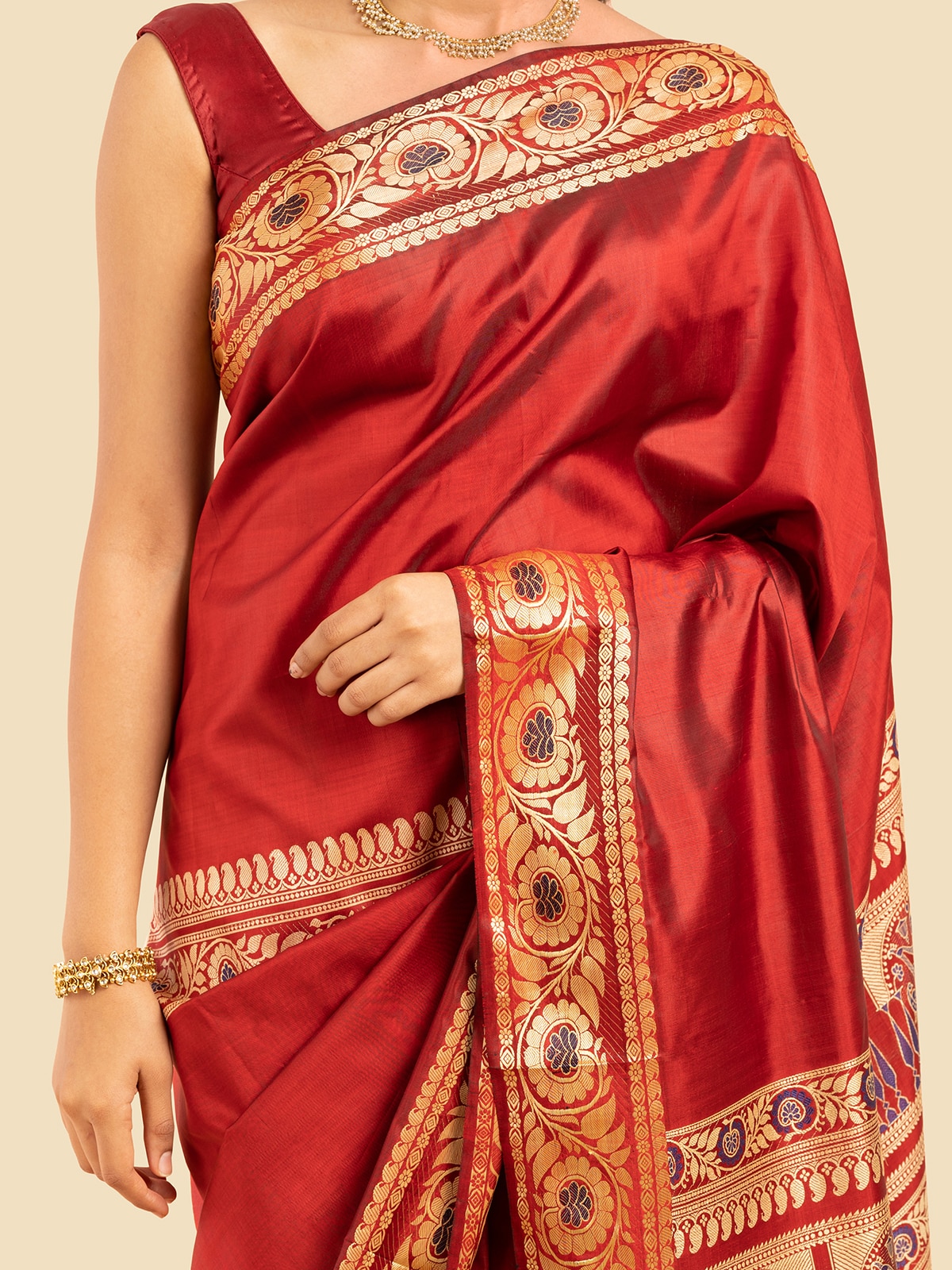 Close-up of red mulberry silk Baluchari saree focusing on intricate embroidery and silk quality