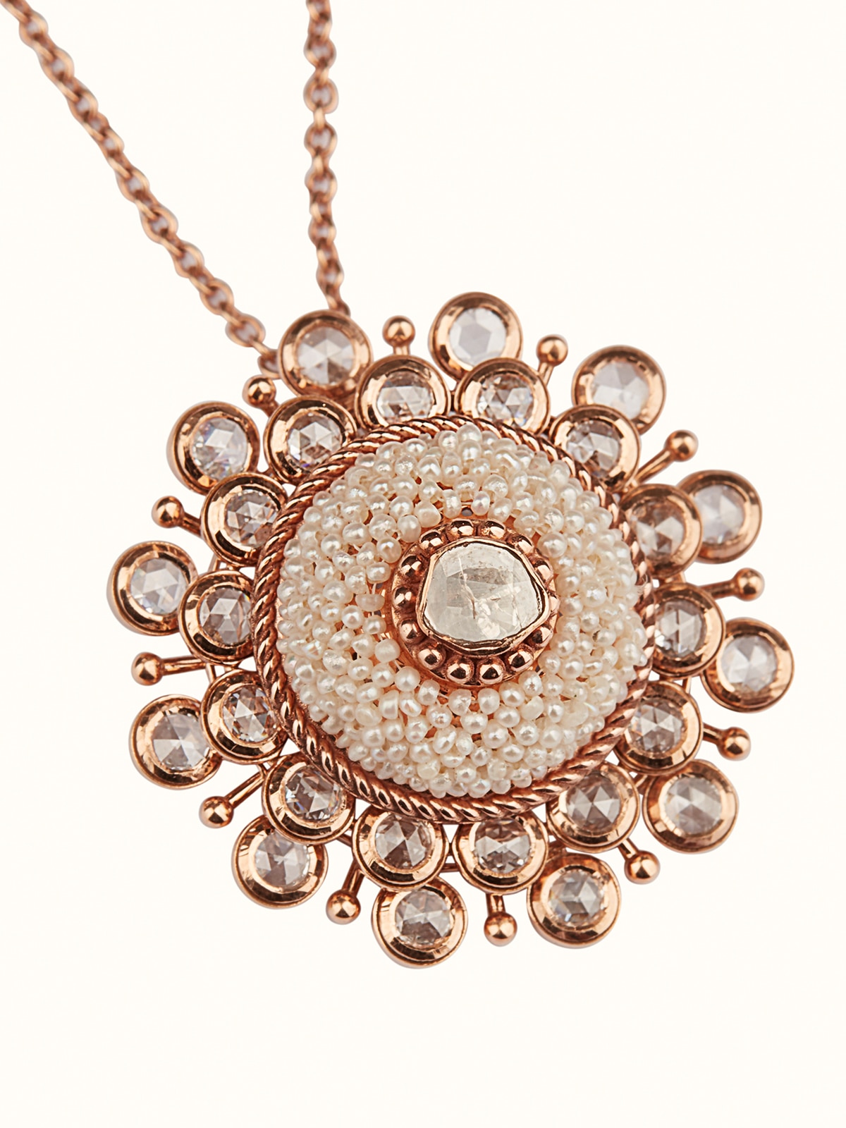 Detailed view of Pearl Pirohi 18 Karat Gold pendant and chain featuring a central pearl and polished gold design.