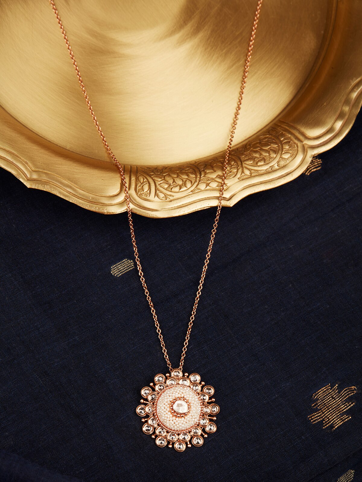 Top view of Pearl Pirohi pendant in 18 Karat Gold featuring a central pearl on a matching gold chain.