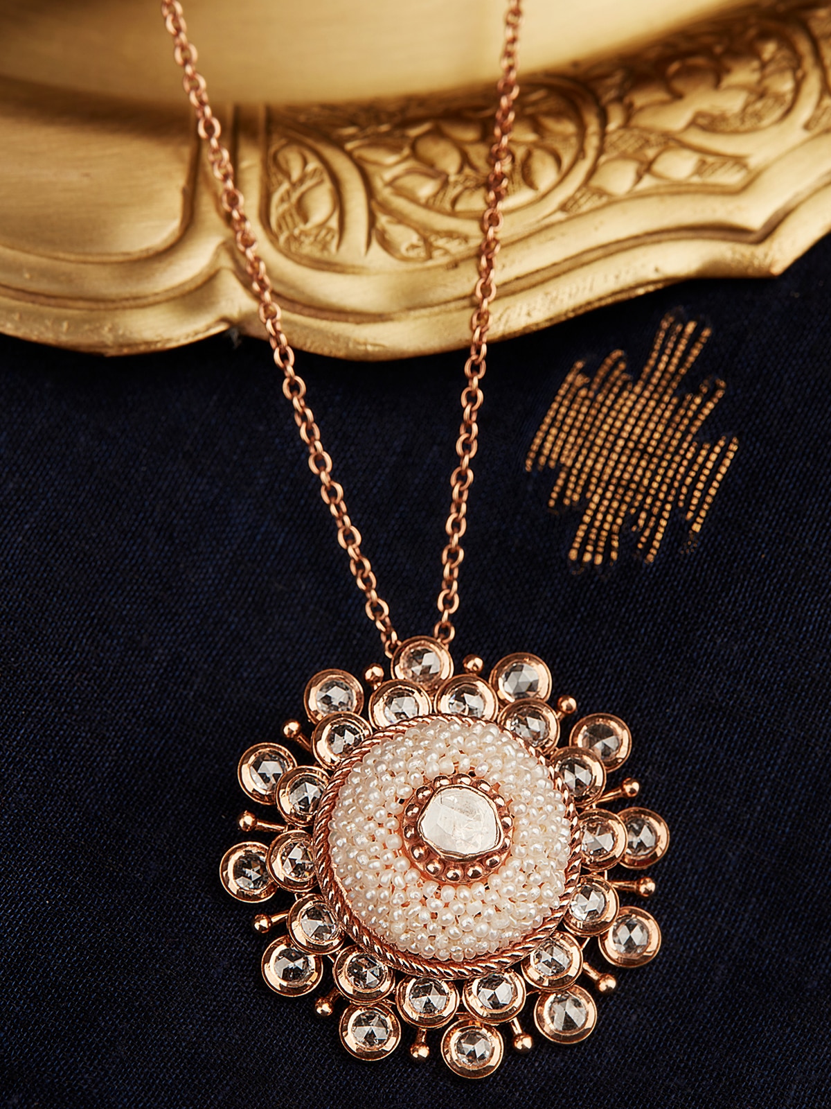 Close-up view of Pearl Pirohi 18 Karat Gold pendant and chain highlighting the pearl centerpiece and gold craftsmanship.