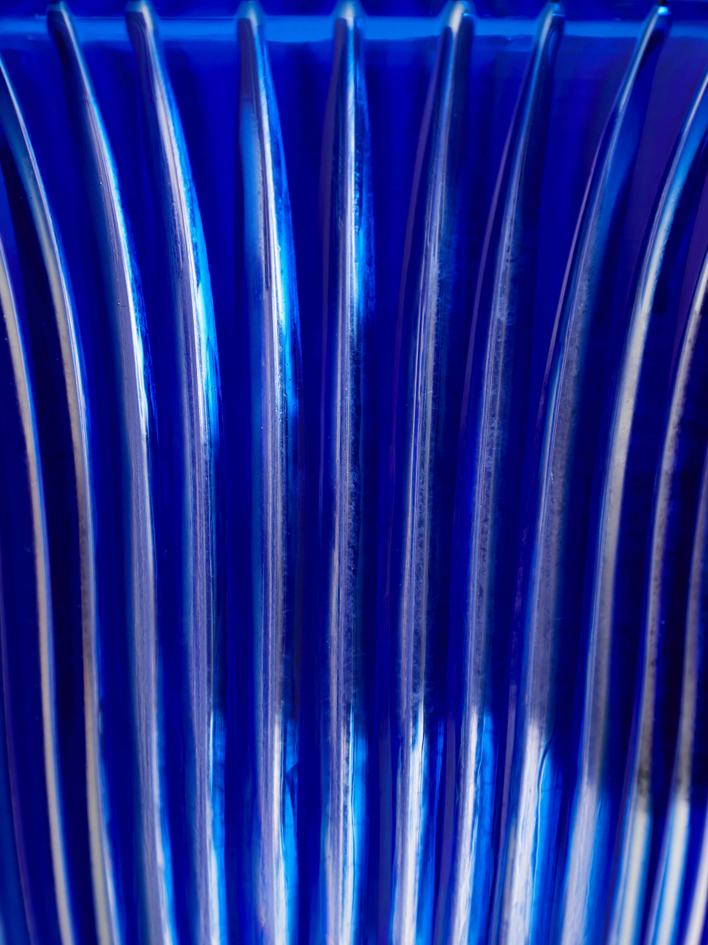 Side view of Blue Glass Table Vase highlighting its elegant curvature and glossy finish