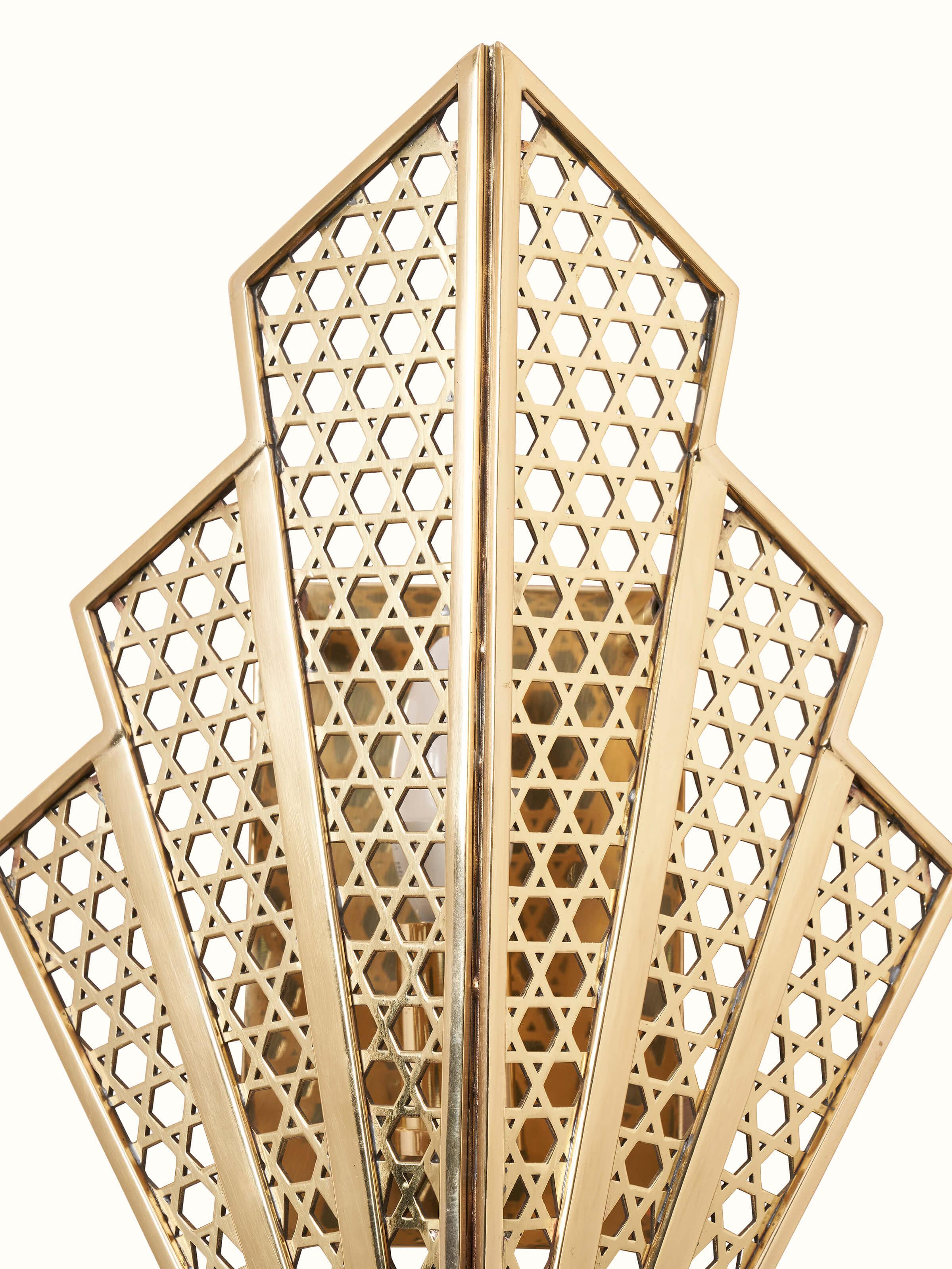 Close-up view of Nakash Brass Galaxy Triangular Wall Light emphasizing the detailed craftsmanship in the brass.