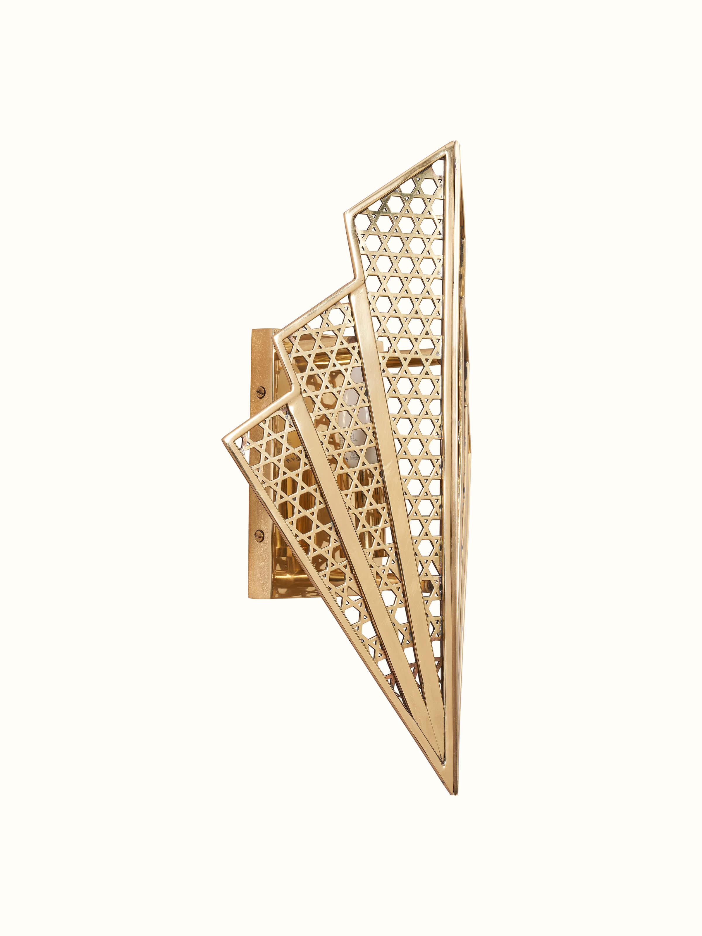 Side view of Nakash Brass Galaxy Triangular Wall Light showing the elegant triangular design and light emission.