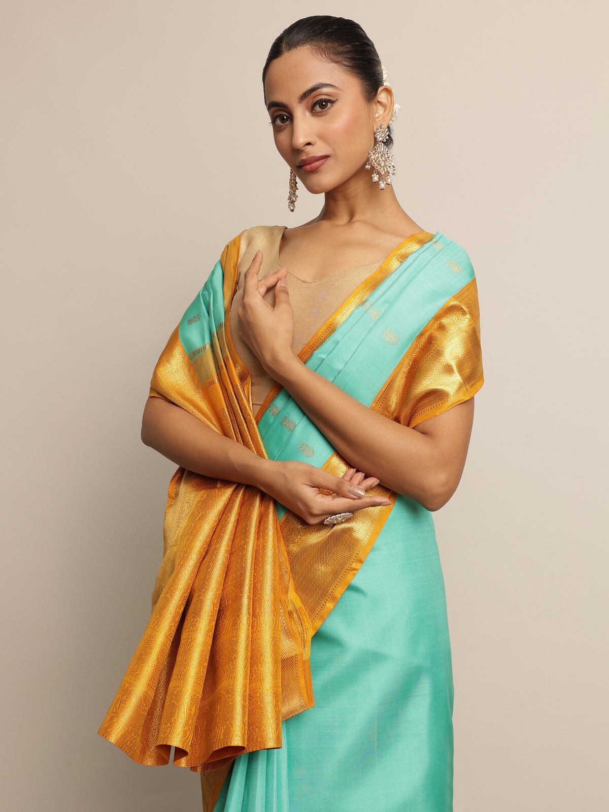 Detailed look at turquoise silk saree - elegant side pose