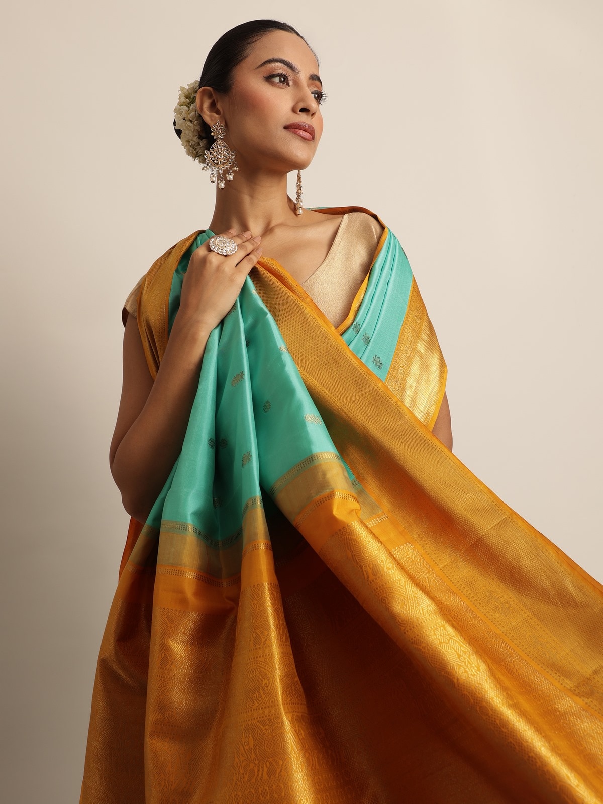 Model in turquoise silk Kancheepuram saree - back profile