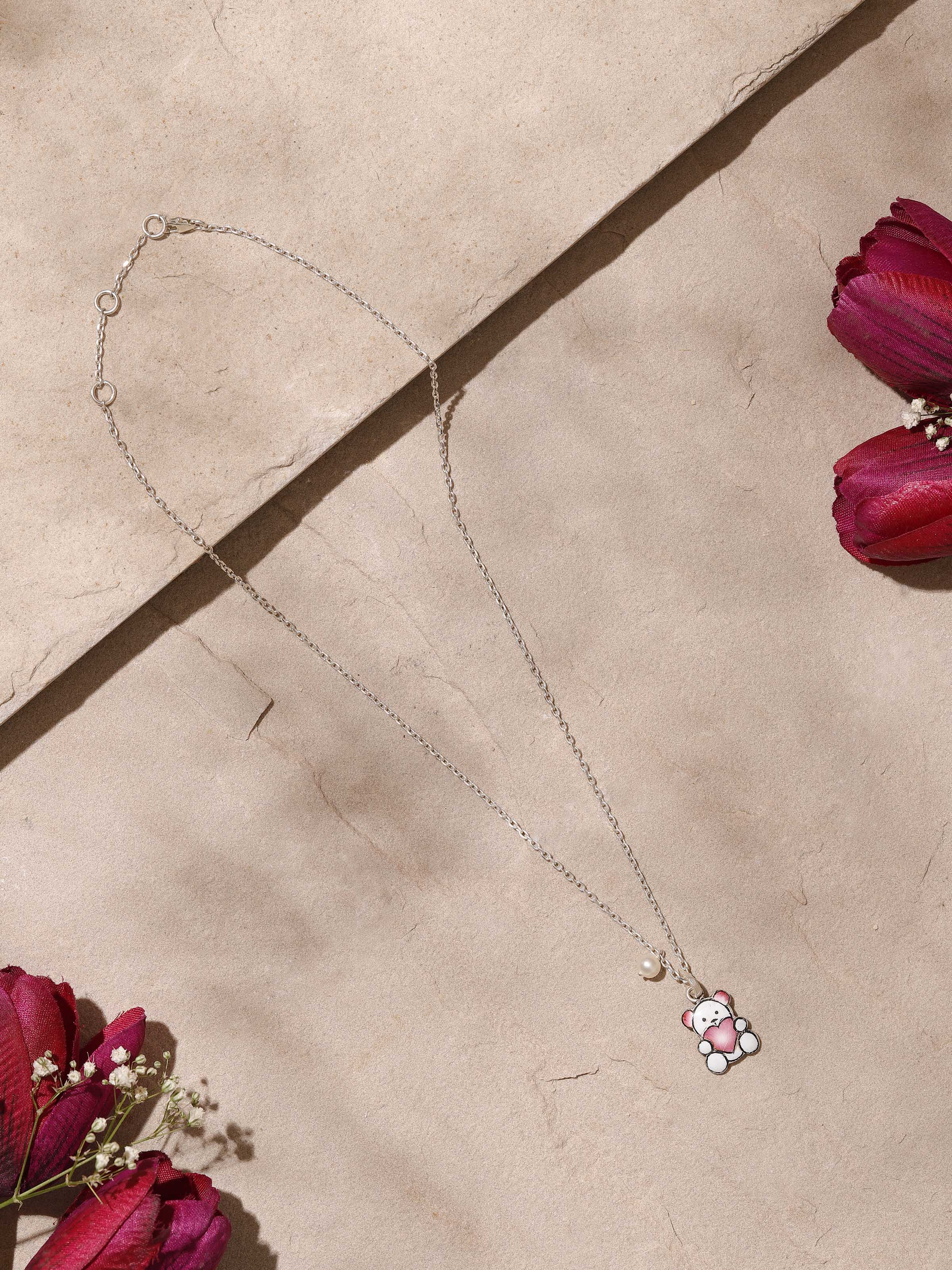 Close-up side view showcasing detailed Meenakari design on silver pendant and chain