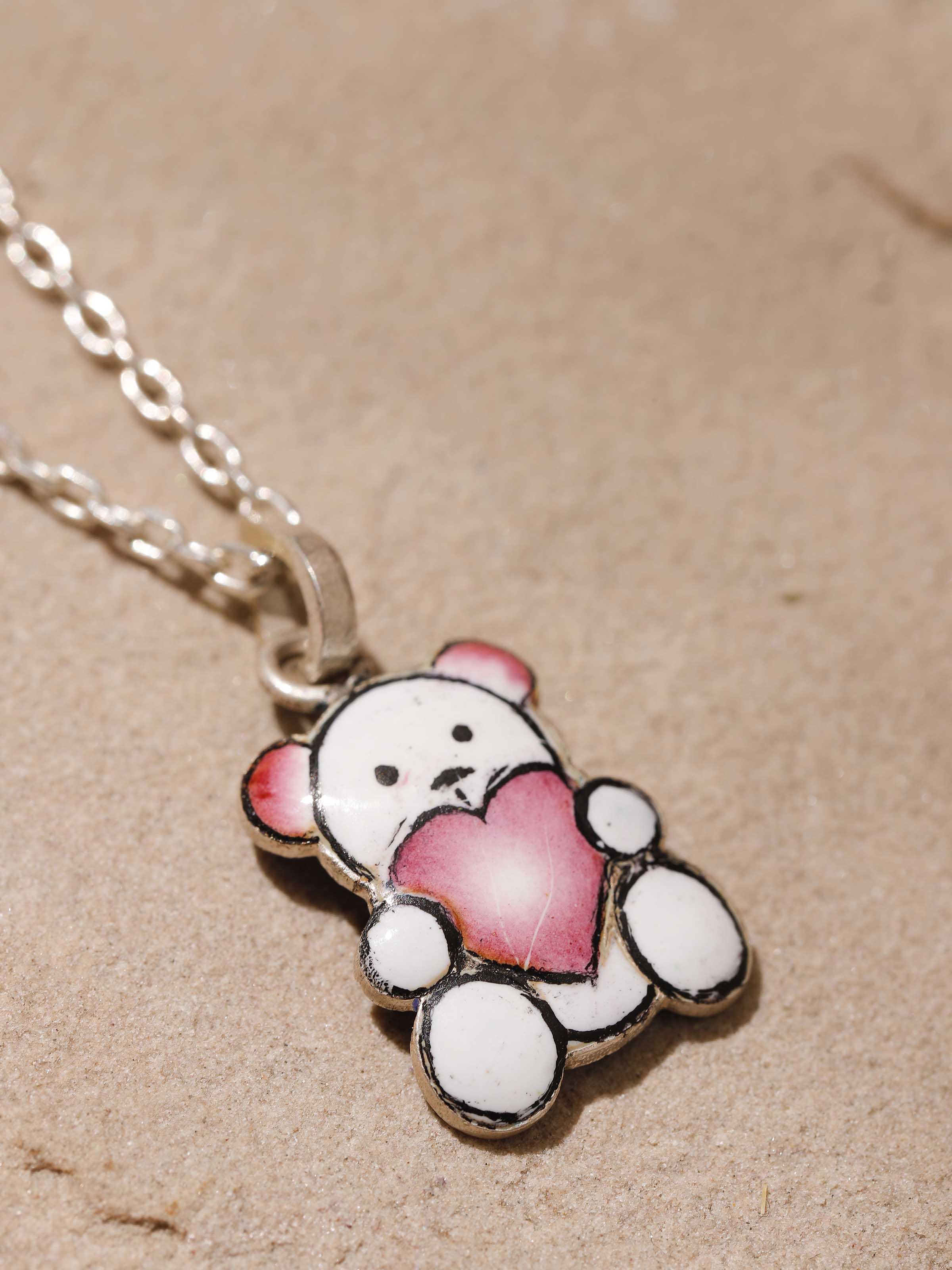 Detailed shot focusing on silver texture and colorful Meenakari artistry of pendant and chain