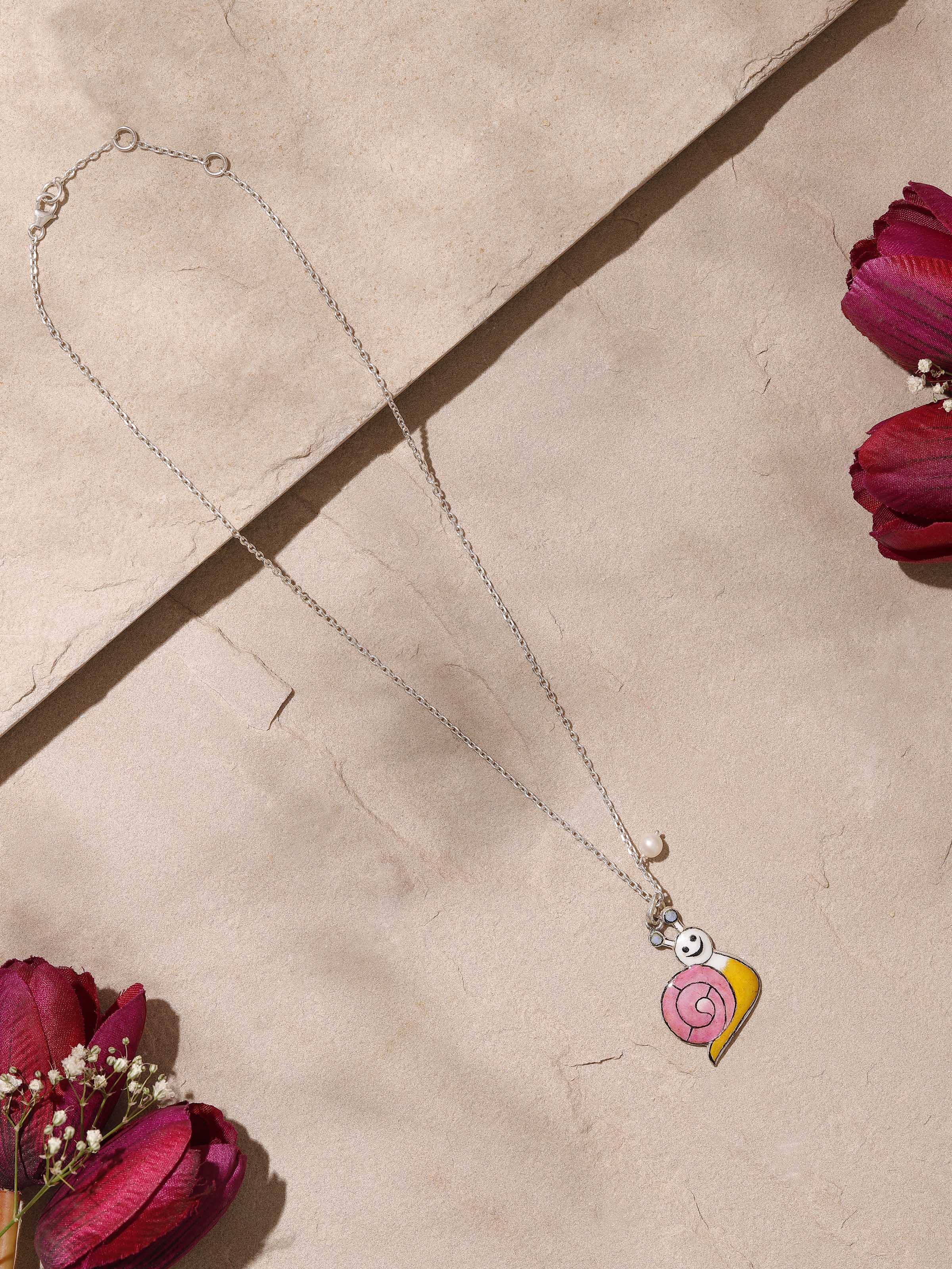 Angled side view focusing on meenakari detailing and chain attachment on pendant